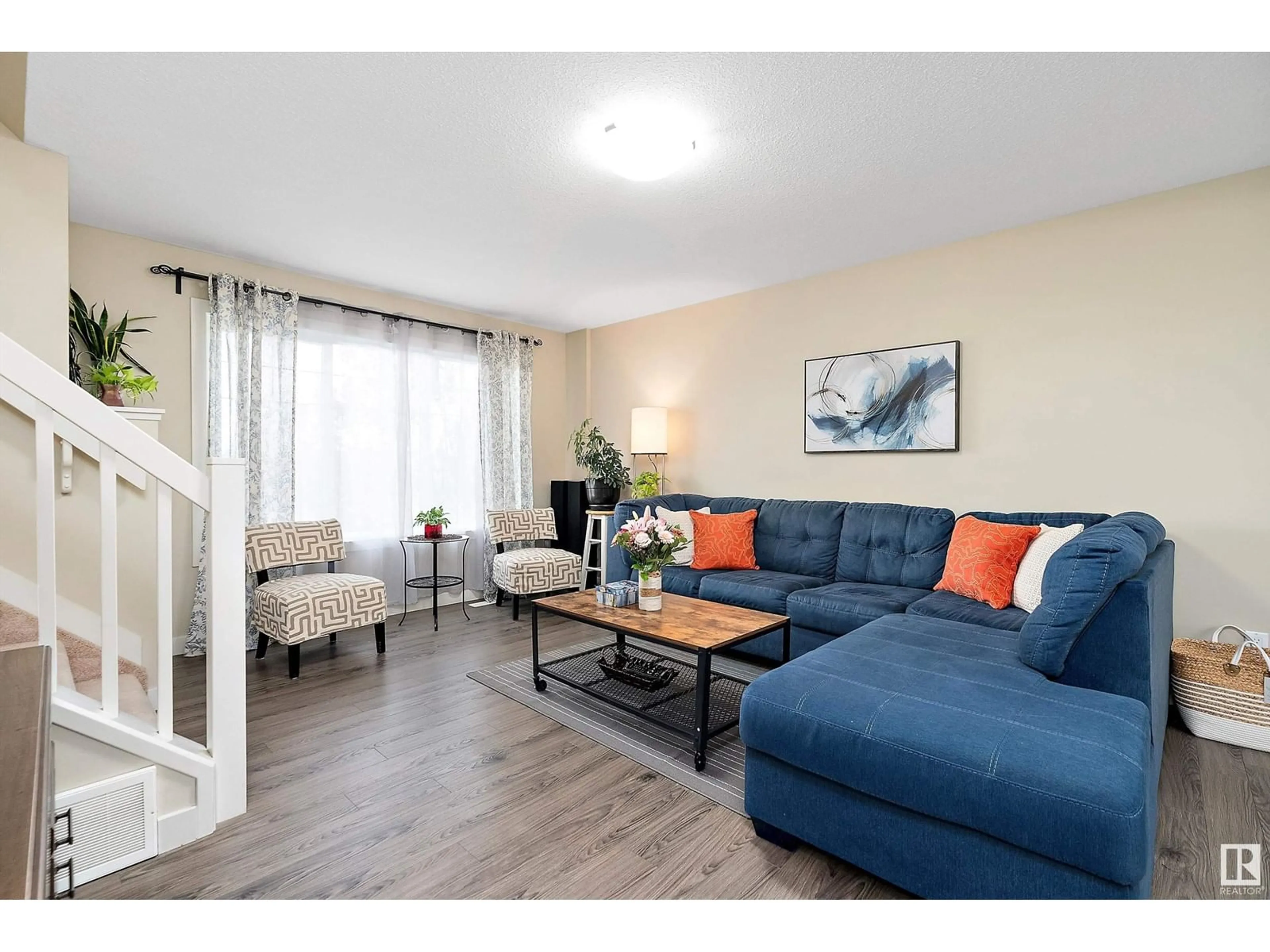 Living room with furniture, wood/laminate floor for NW - 4229 30 ST, Edmonton Alberta T6X1V1