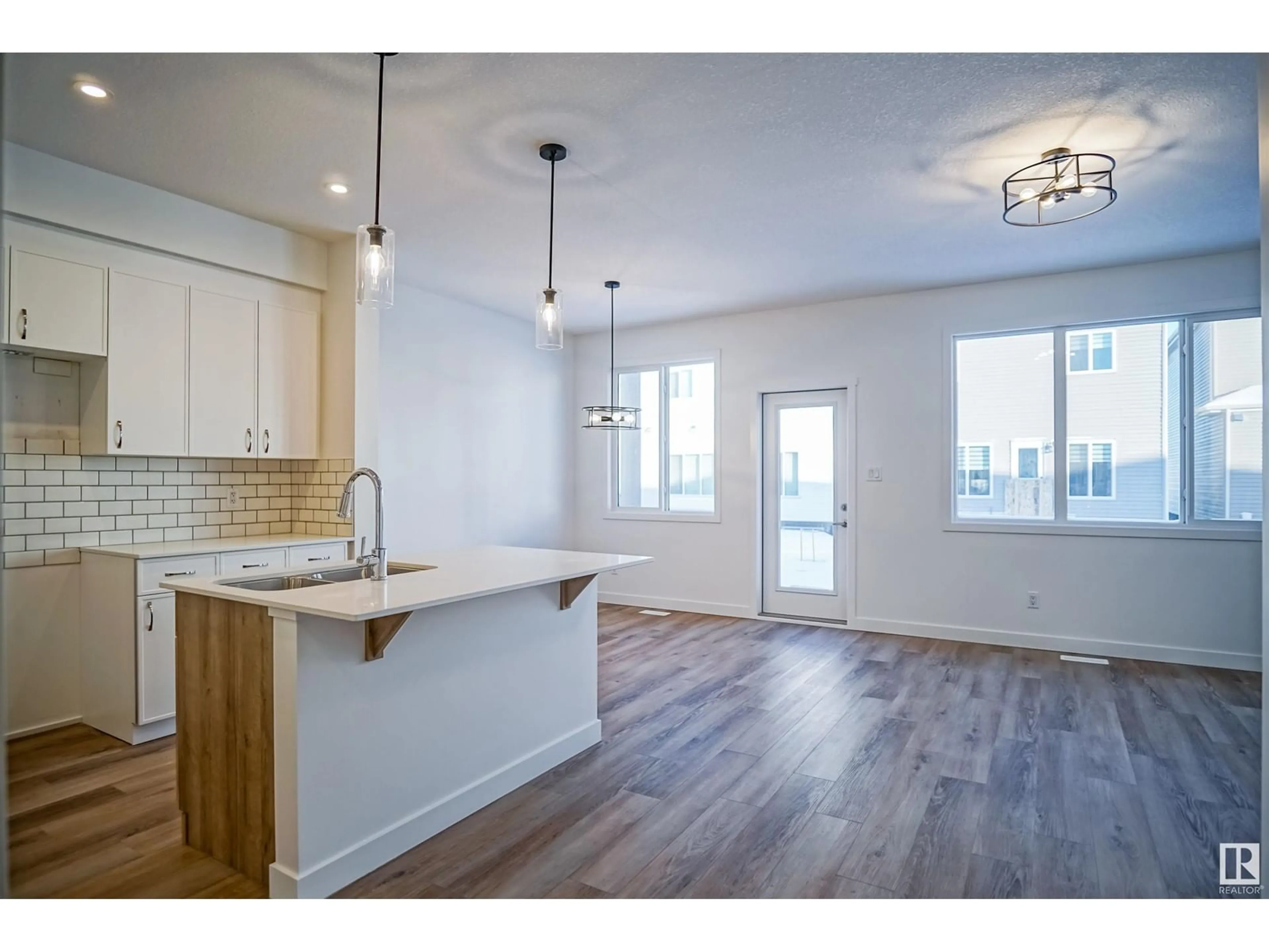 Open concept kitchen, wood/laminate floor for NE - 17345 6A ST, Edmonton Alberta T5Y4E9