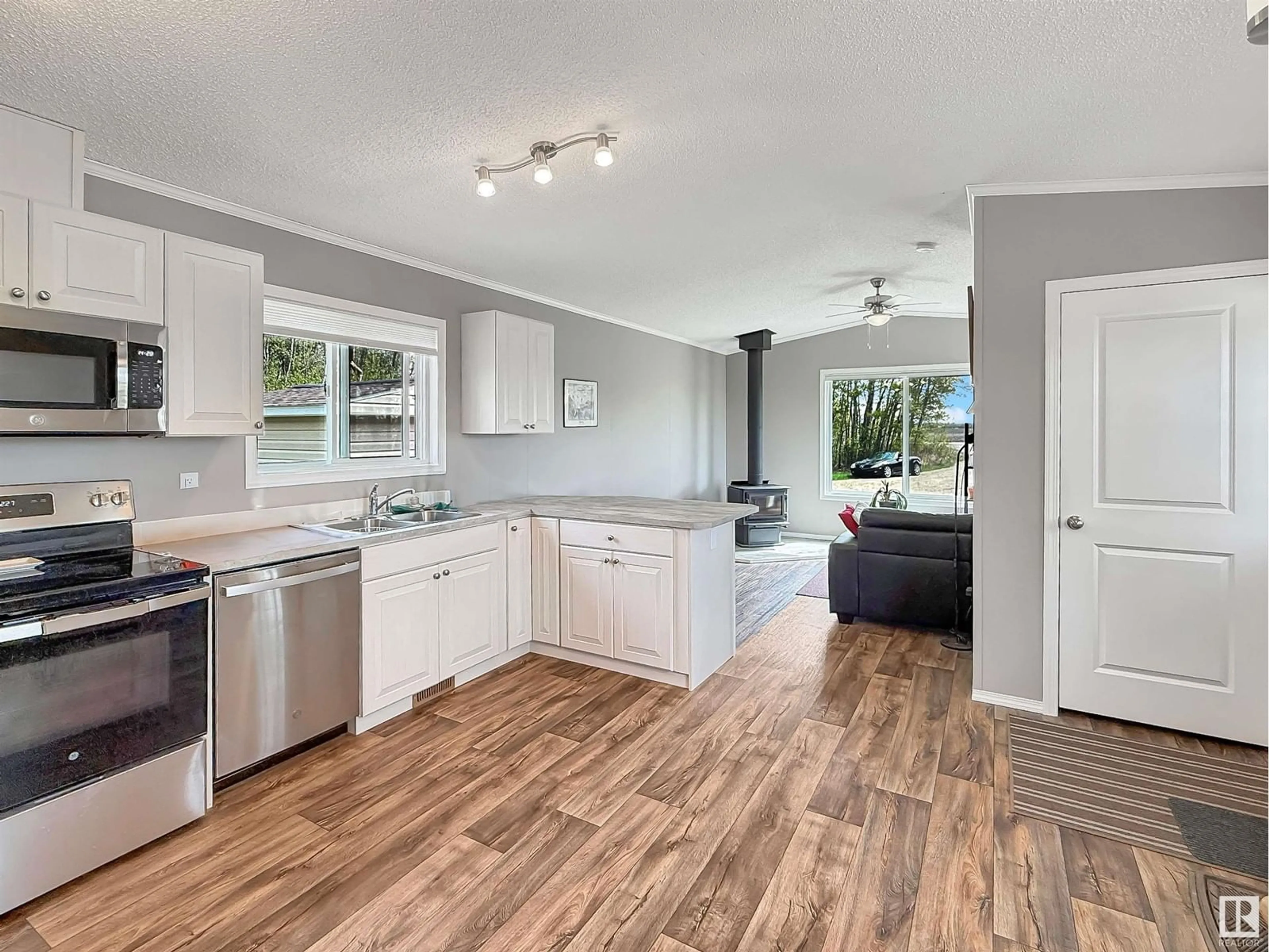 Open concept kitchen, wood/laminate floor for #120 - 120 TWP ROAD 490, Rural Leduc County Alberta T0C0V0