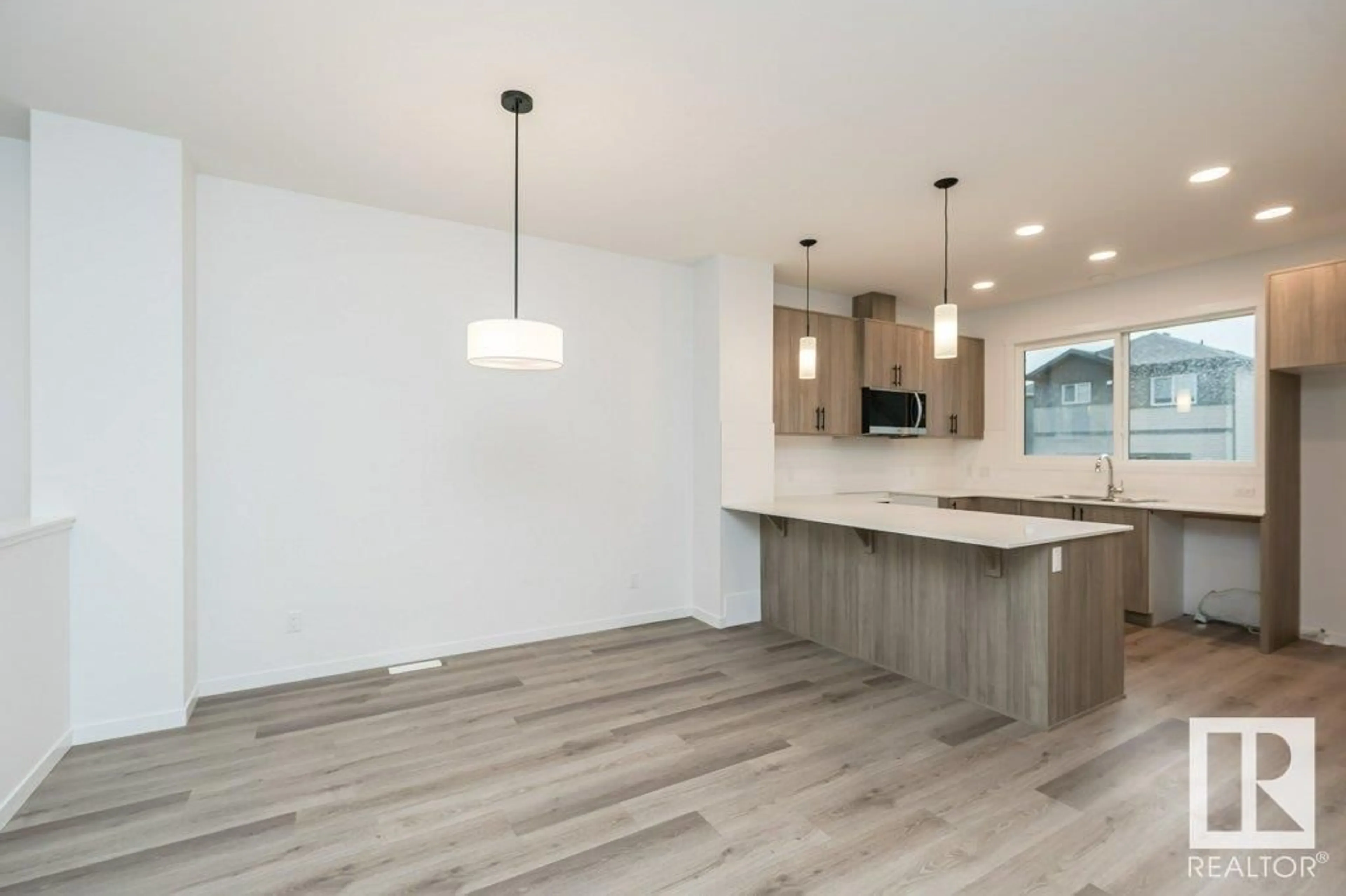 Open concept kitchen, wood/laminate floor for 6253 175A AV, Edmonton Alberta T5Y4A5
