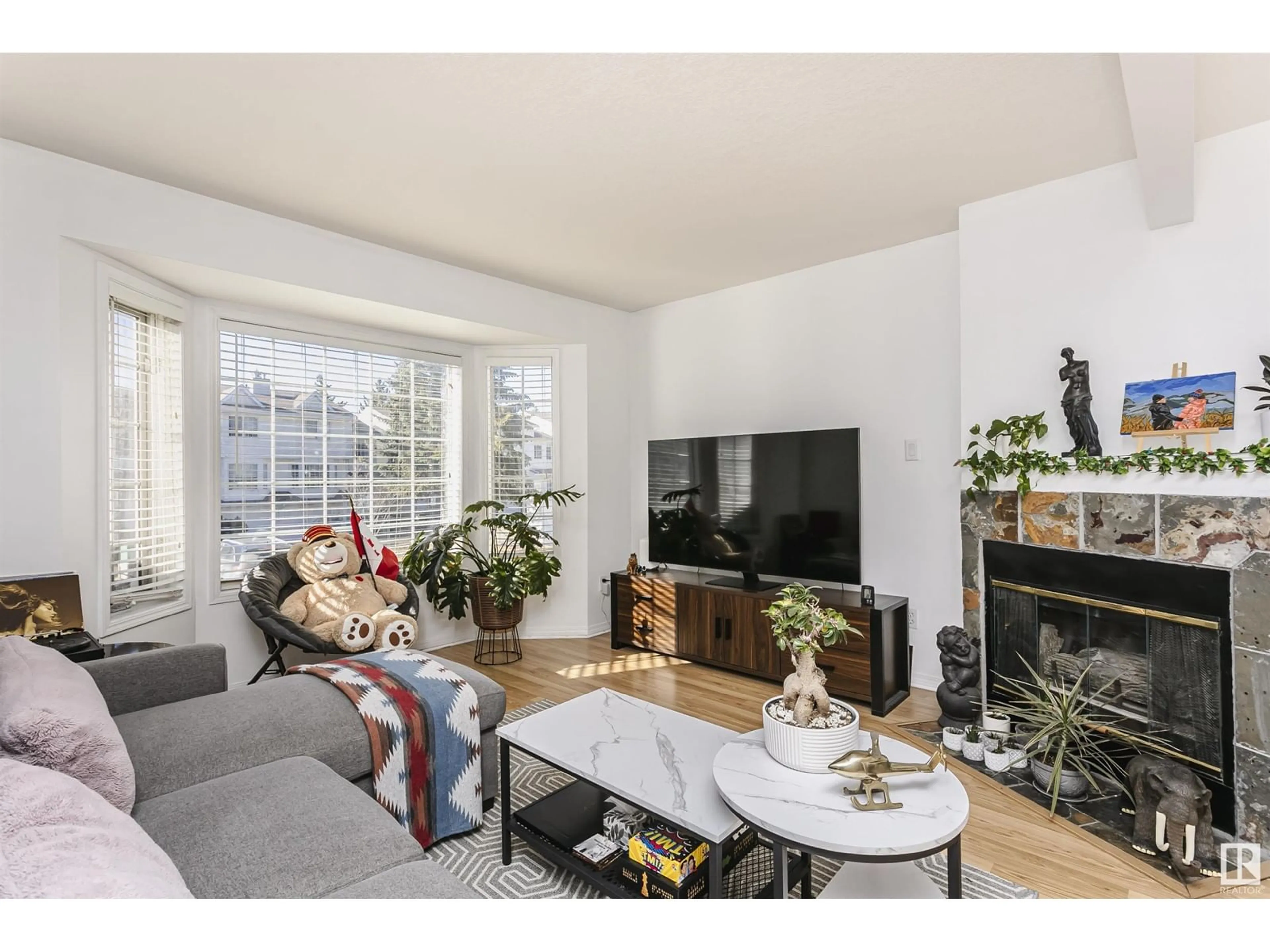 Living room with furniture, wood/laminate floor for 9775 176 ST NW, Edmonton Alberta T5T6B3