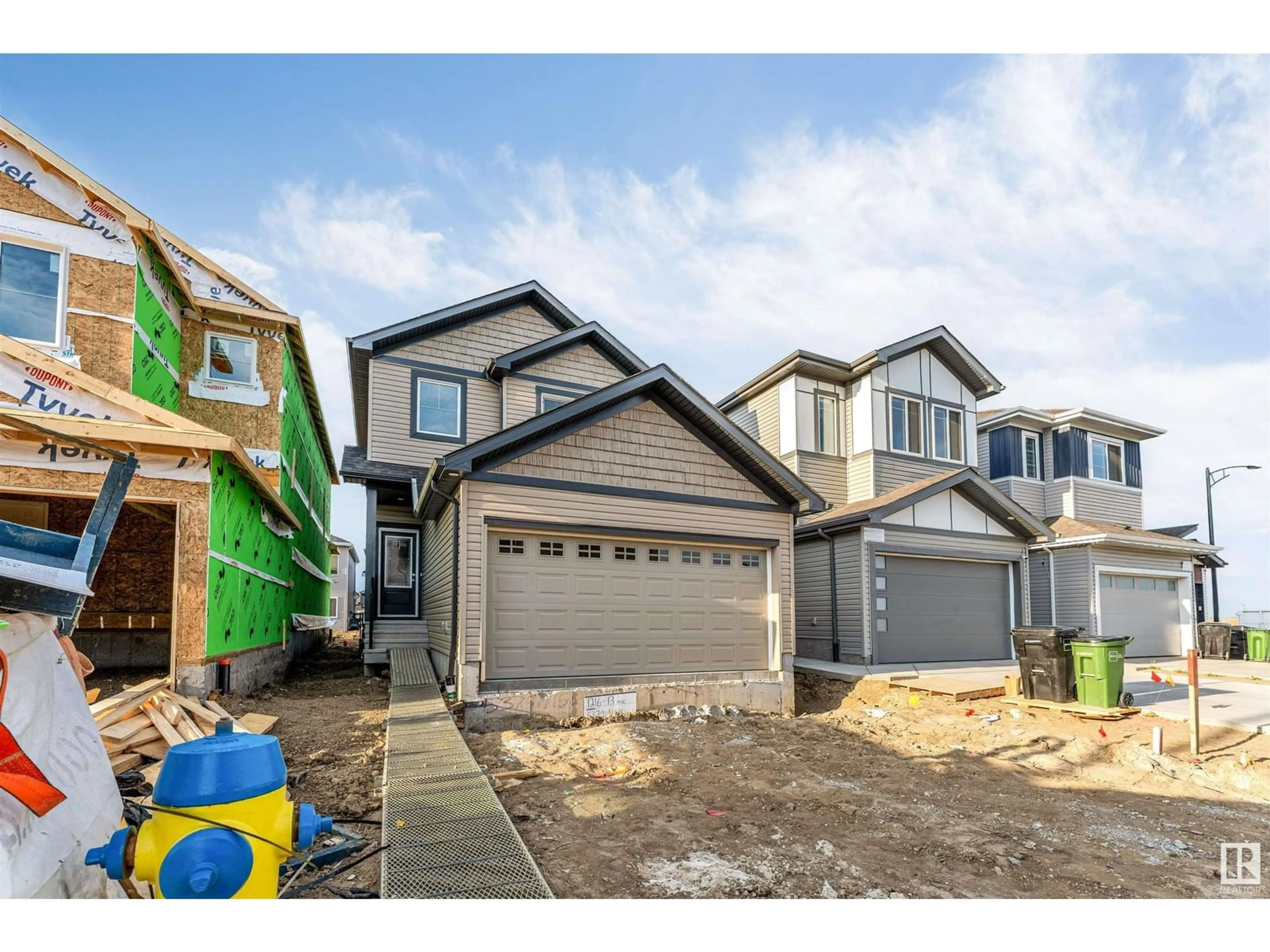Home with vinyl exterior material, street for 1216 13 AVE NW, Edmonton Alberta T6T2W2