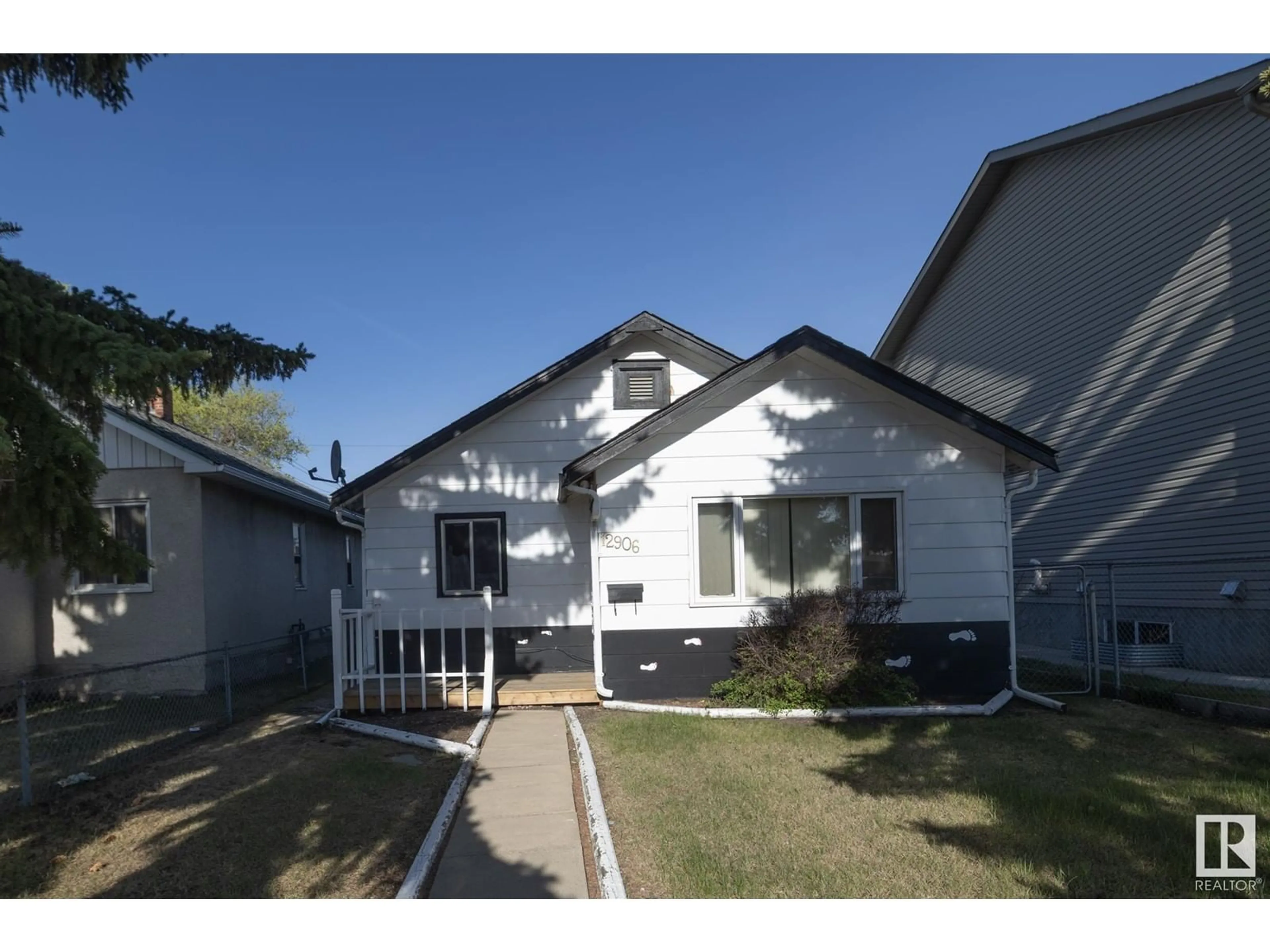 Home with vinyl exterior material, street for 12906 128 ST, Edmonton Alberta T5L1E5