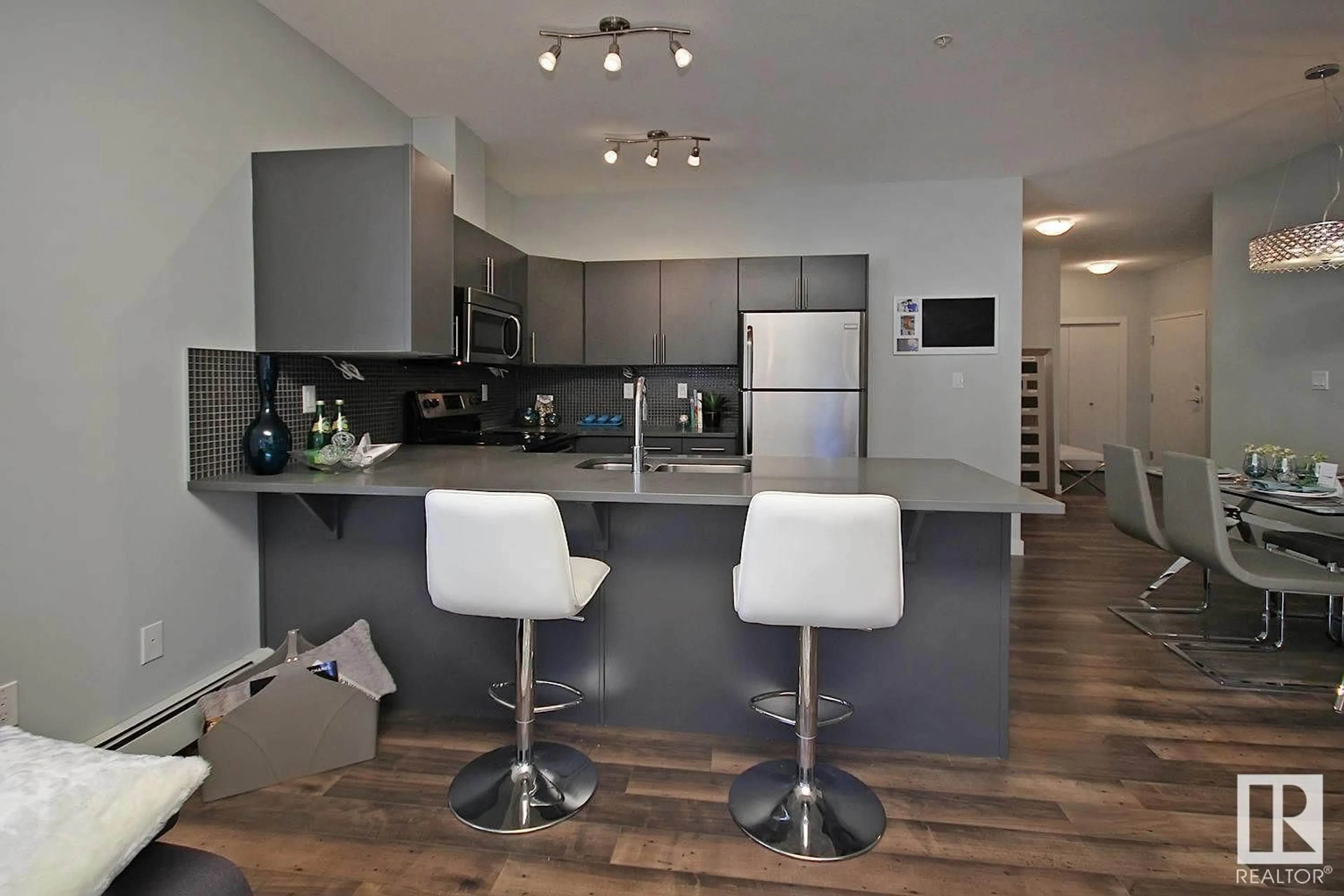 Open concept kitchen, wood/laminate floor for #104 - 10611 117 ST, Edmonton Alberta T5H0G6
