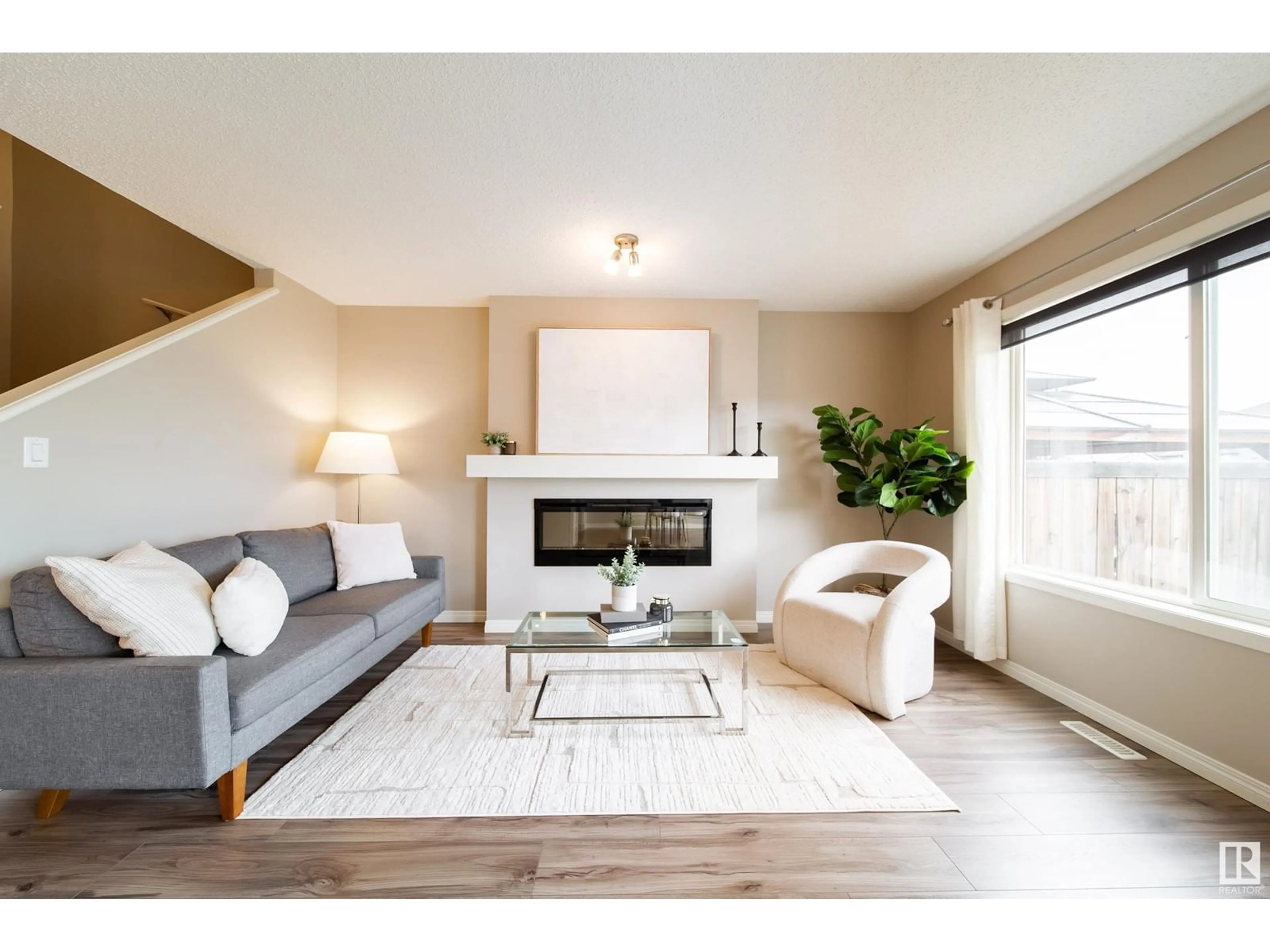 Living room with furniture, wood/laminate floor for 7705 24 AV, Edmonton Alberta T6X1S6