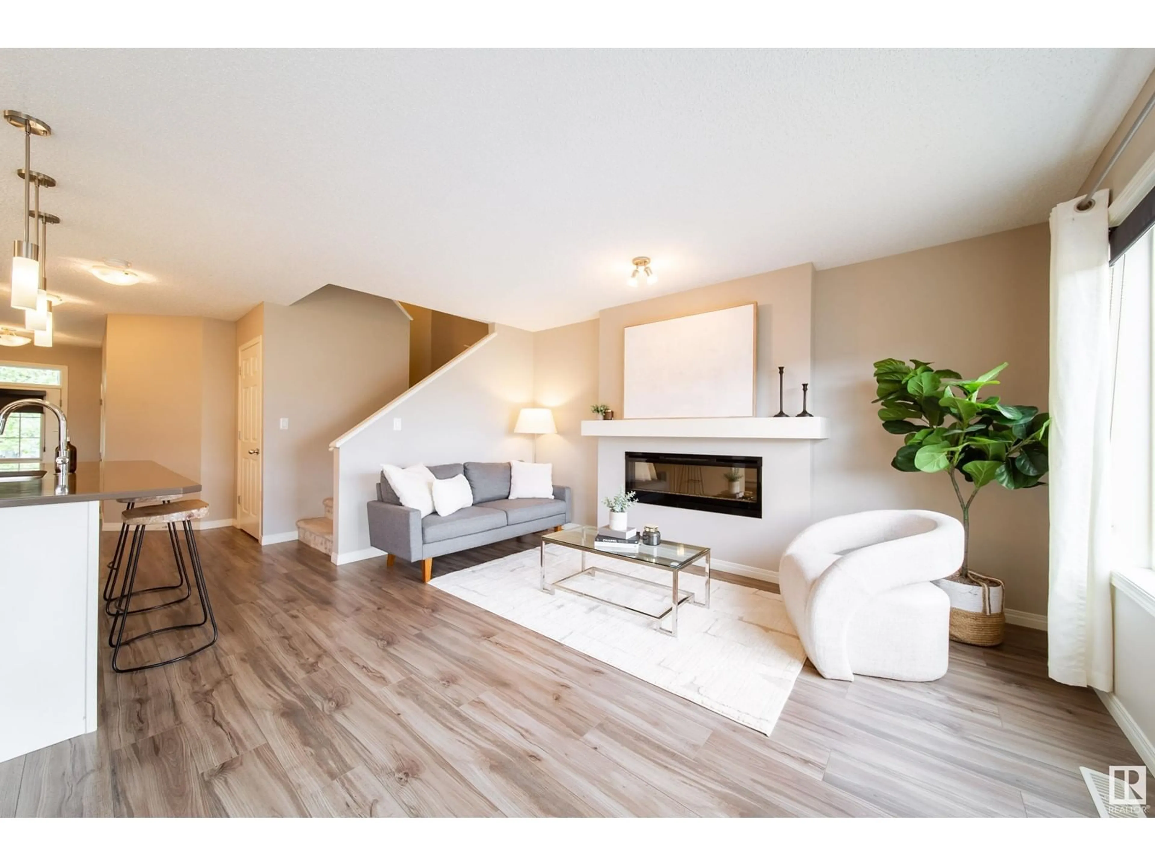 Living room with furniture, wood/laminate floor for 7705 24 AV, Edmonton Alberta T6X1S6
