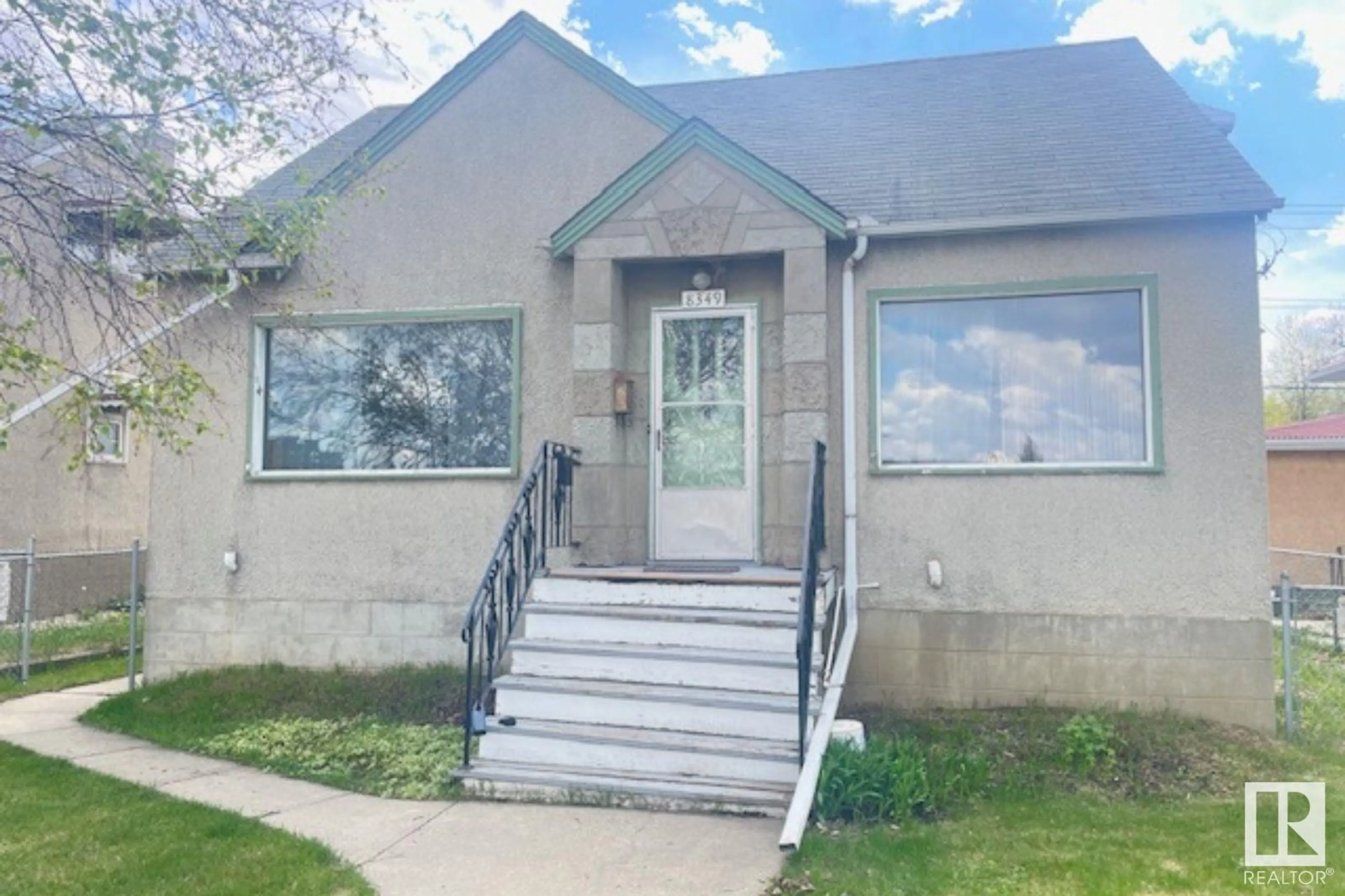 Home with vinyl exterior material, street for 8349 82 AV, Edmonton Alberta T6C0Y5