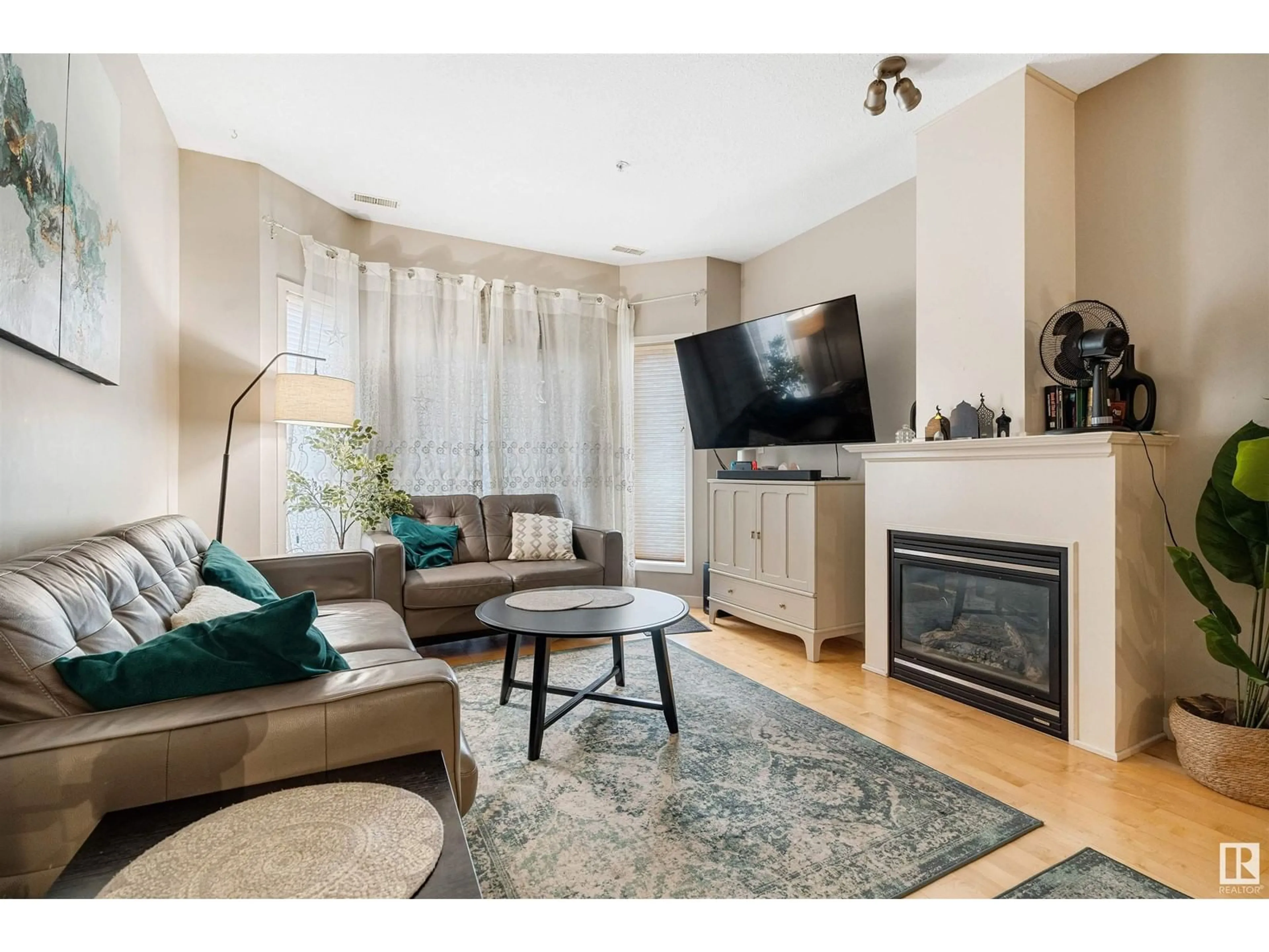 Living room with furniture, wood/laminate floor for #102 - 4312 139 AV, Edmonton Alberta T5Y3J4