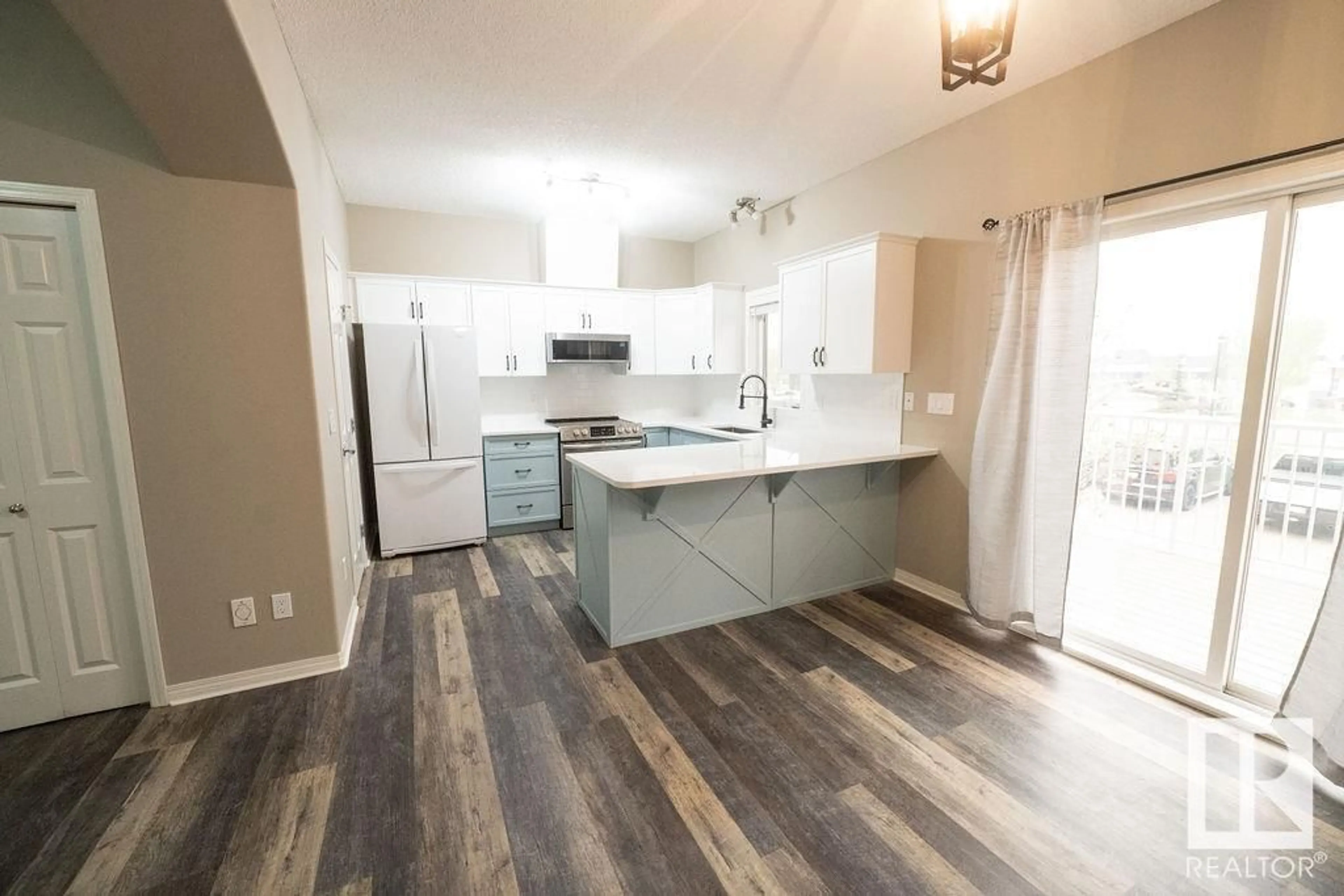 Open concept kitchen, wood/laminate floor for 5102 - 46 30 AV, Beaumont Alberta T4X0A9