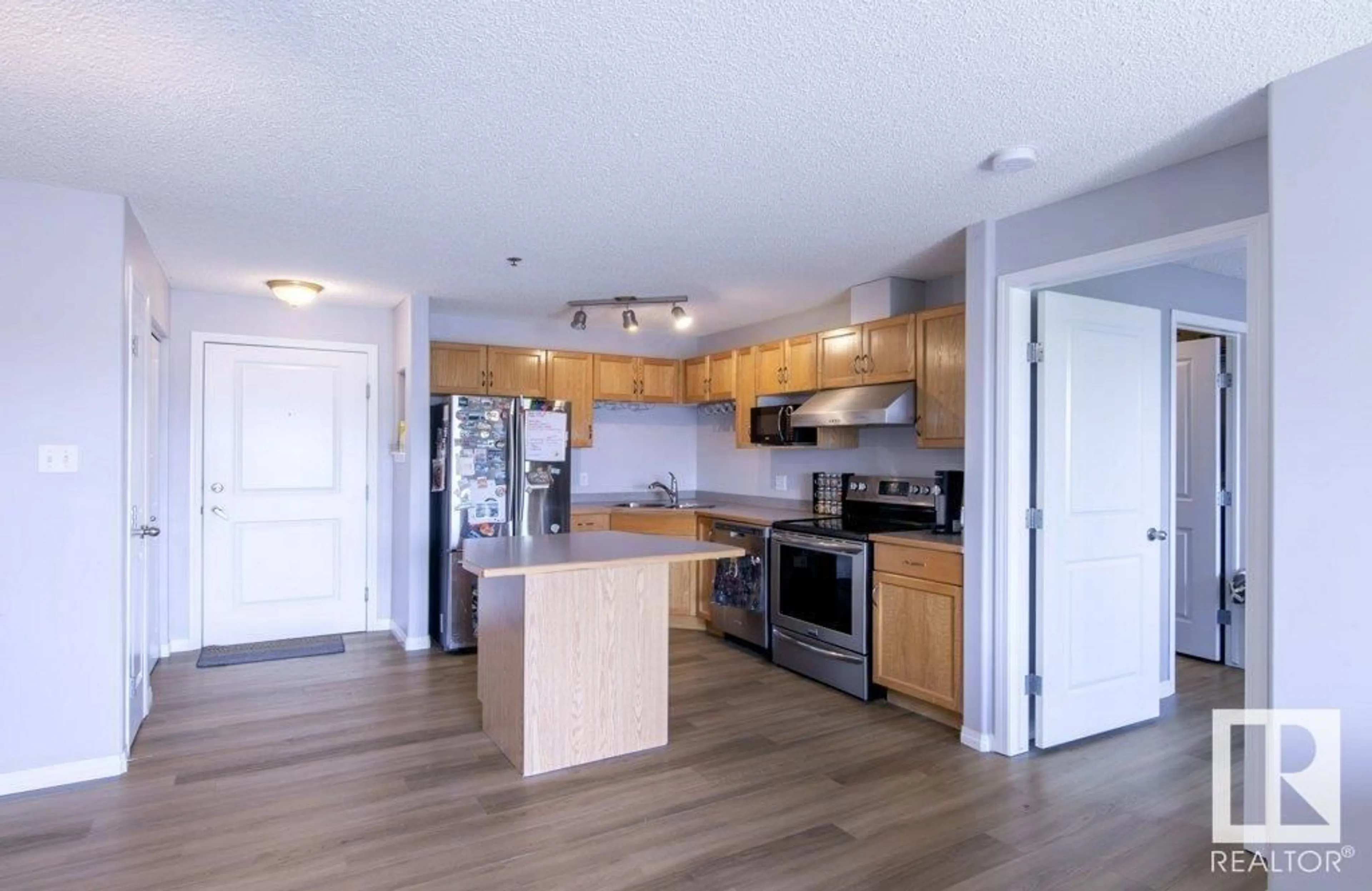 Open concept kitchen, wood/laminate floor for 336 - 2305 35A AV, Edmonton Alberta T6T1Z2