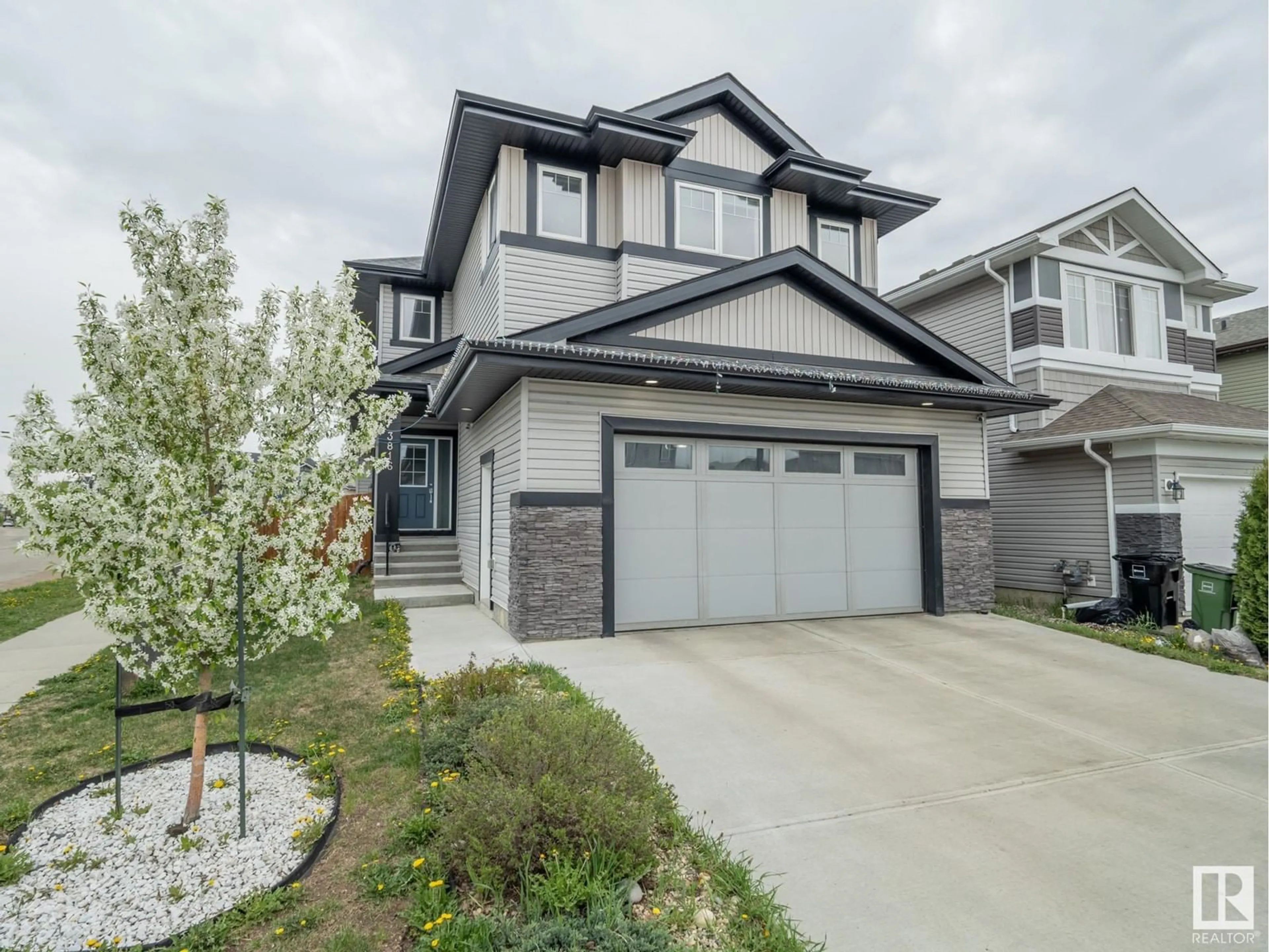 Home with vinyl exterior material, street for NW - 3816 168 AV, Edmonton Alberta T5Y0X8