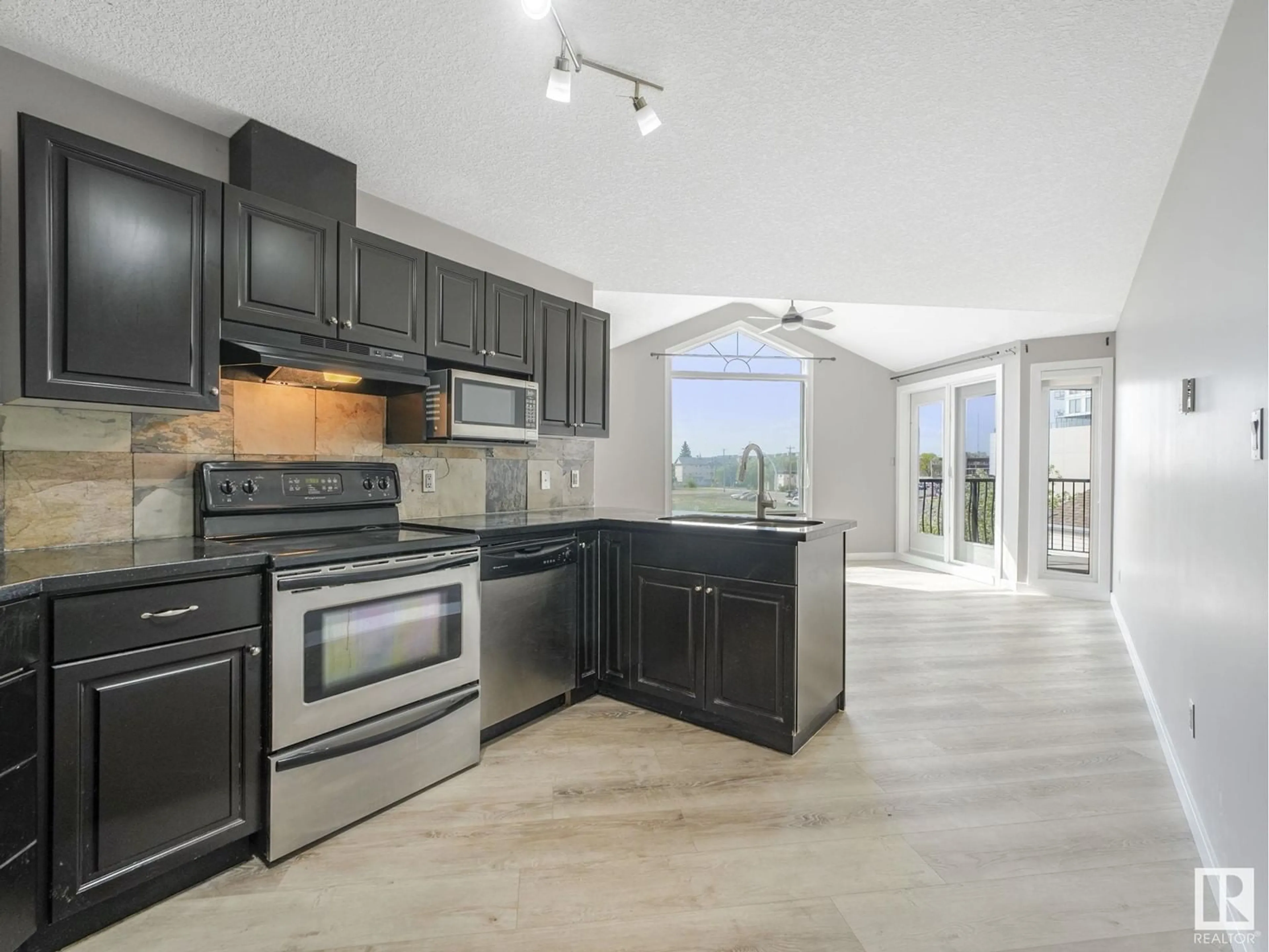 Open concept kitchen, ceramic/tile floor for #303 - 9336 JASPER AV, Edmonton Alberta T5H3T5