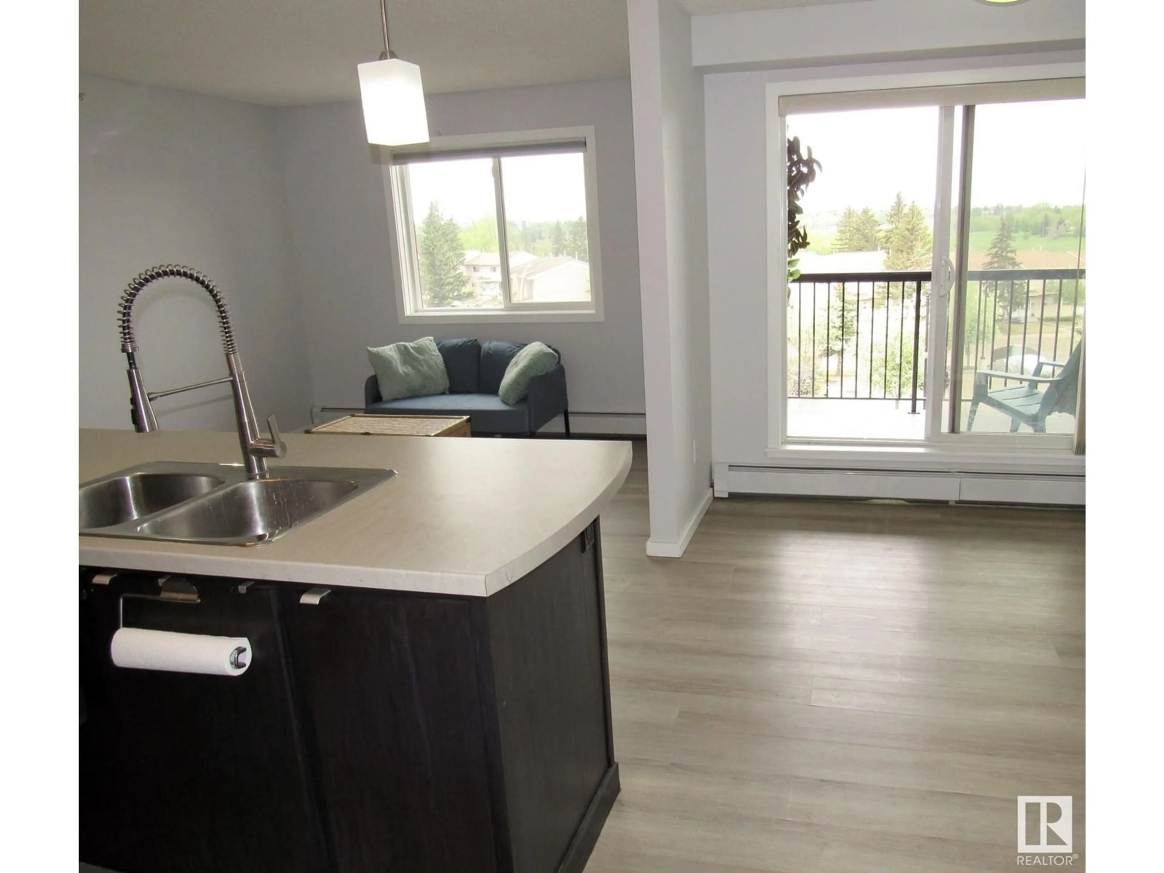 Open concept kitchen, wood/laminate floor for #453 - 1196 HYNDMAN RD, Edmonton Alberta T5A0X8