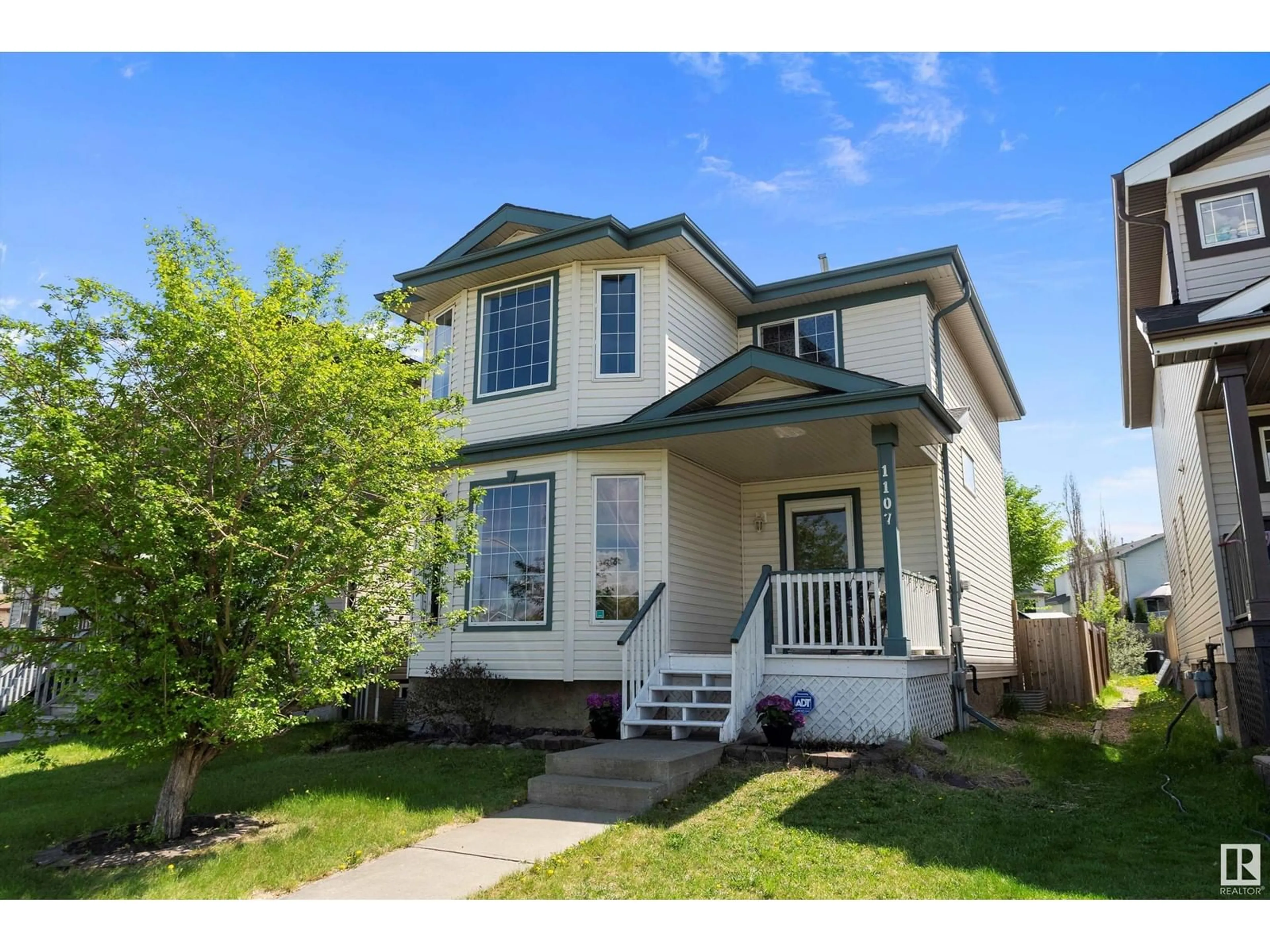 Home with vinyl exterior material, street for 1107 HYNDMAN RD, Edmonton Alberta T5A5J1