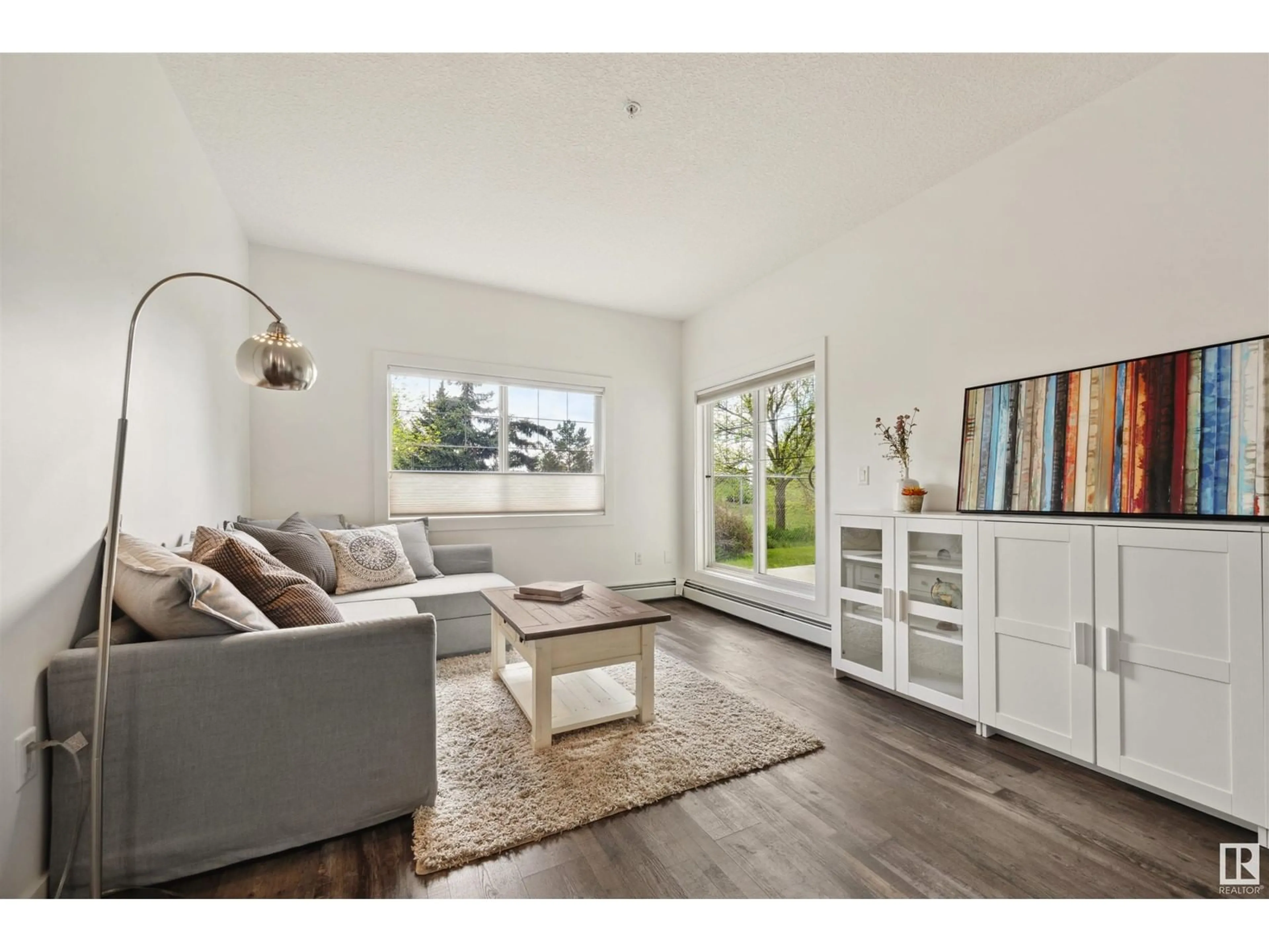 Living room with furniture, wood/laminate floor for #119 - 16807 100 AV, Edmonton Alberta T5P4Z6
