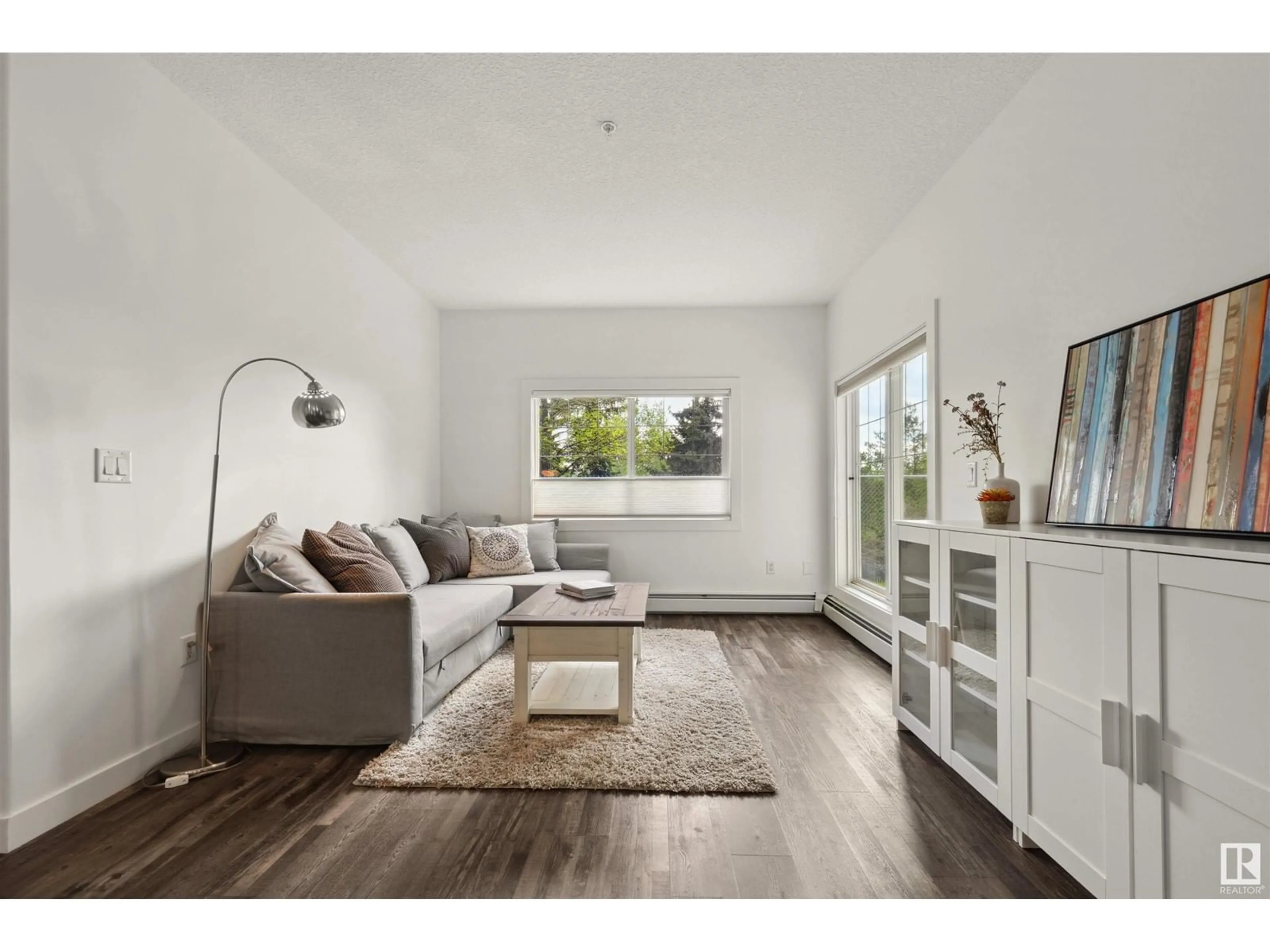 Living room with furniture, wood/laminate floor for #119 - 16807 100 AV, Edmonton Alberta T5P4Z6