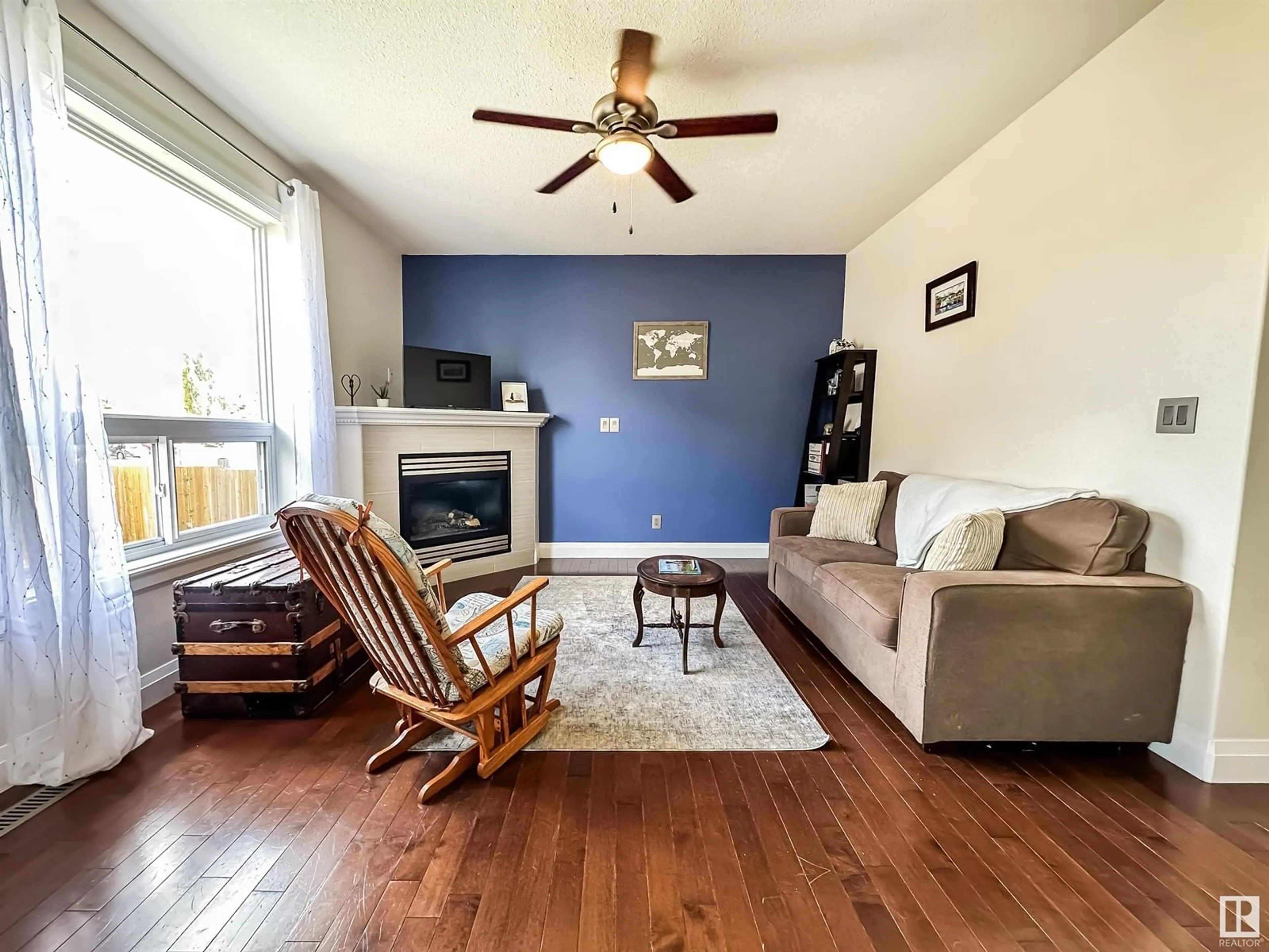 Living room with furniture, wood/laminate floor for 10201 96 ST, Morinville Alberta T8R0B5