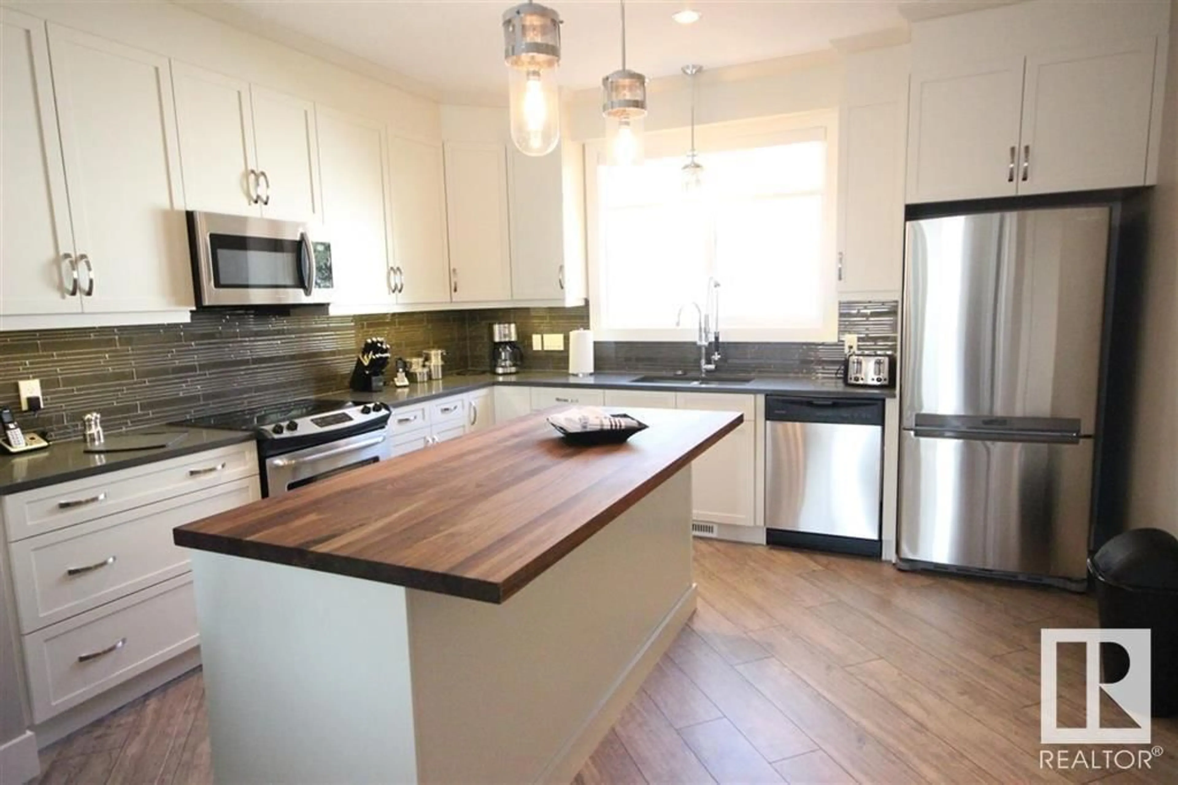 Open concept kitchen, wood/laminate floor for NW - 10604/06/08 61 AV, Edmonton Alberta T6H1L7