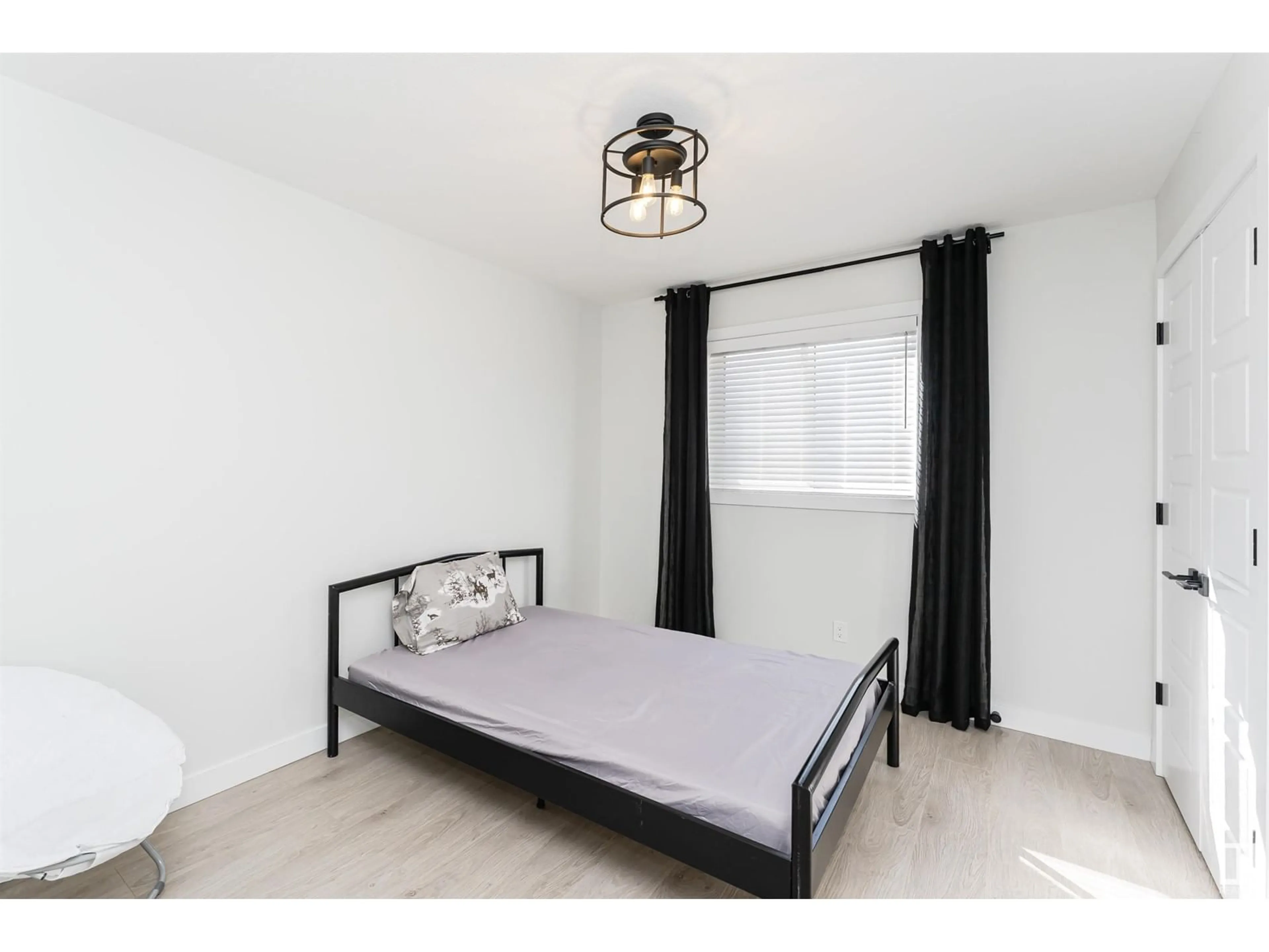 Bedroom with bed, wood/laminate floor for 7343 179 AV, Edmonton Alberta T5Z0M7