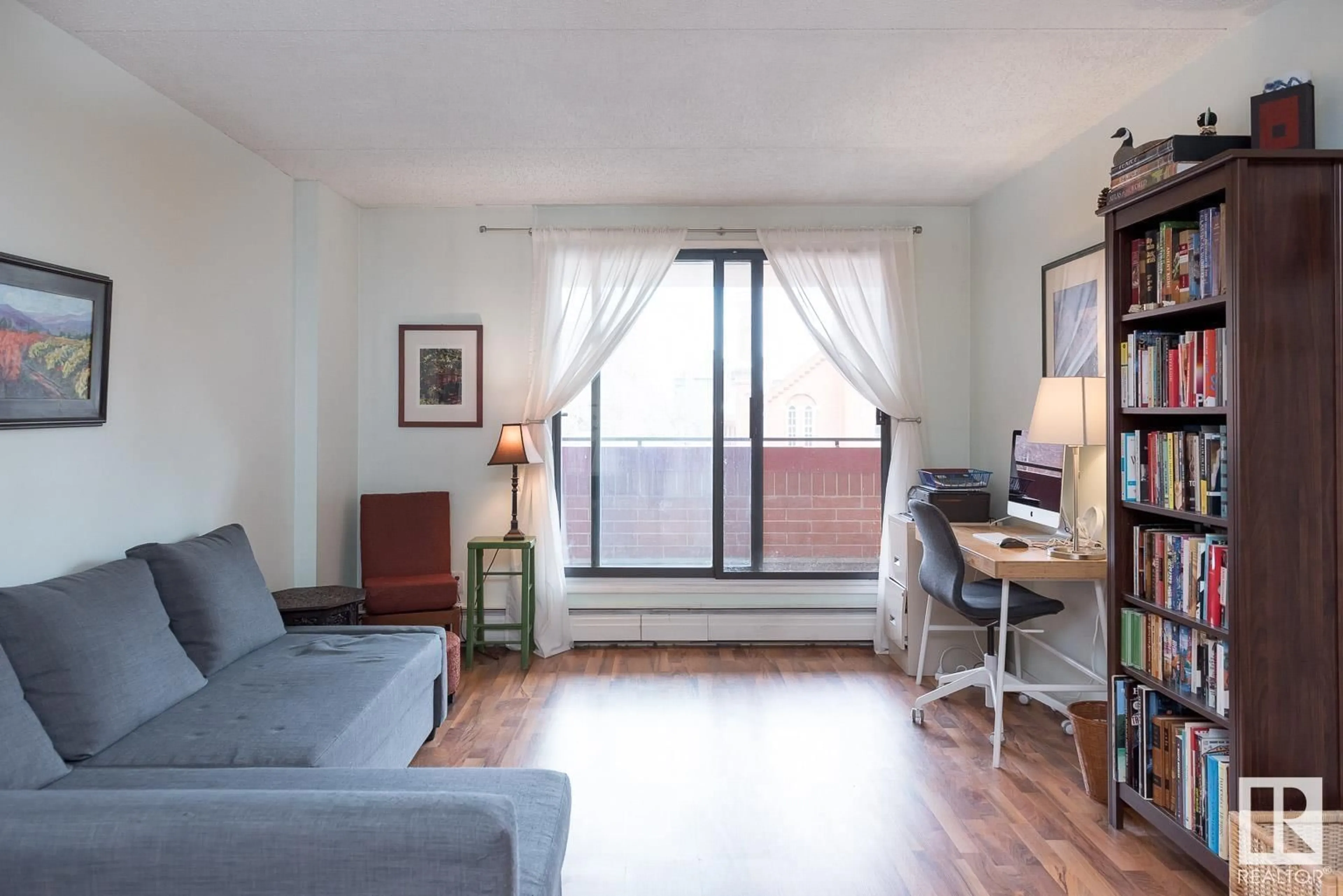 Living room with furniture, wood/laminate floor for 304 - 9917 110 ST, Edmonton Alberta T5K2N4