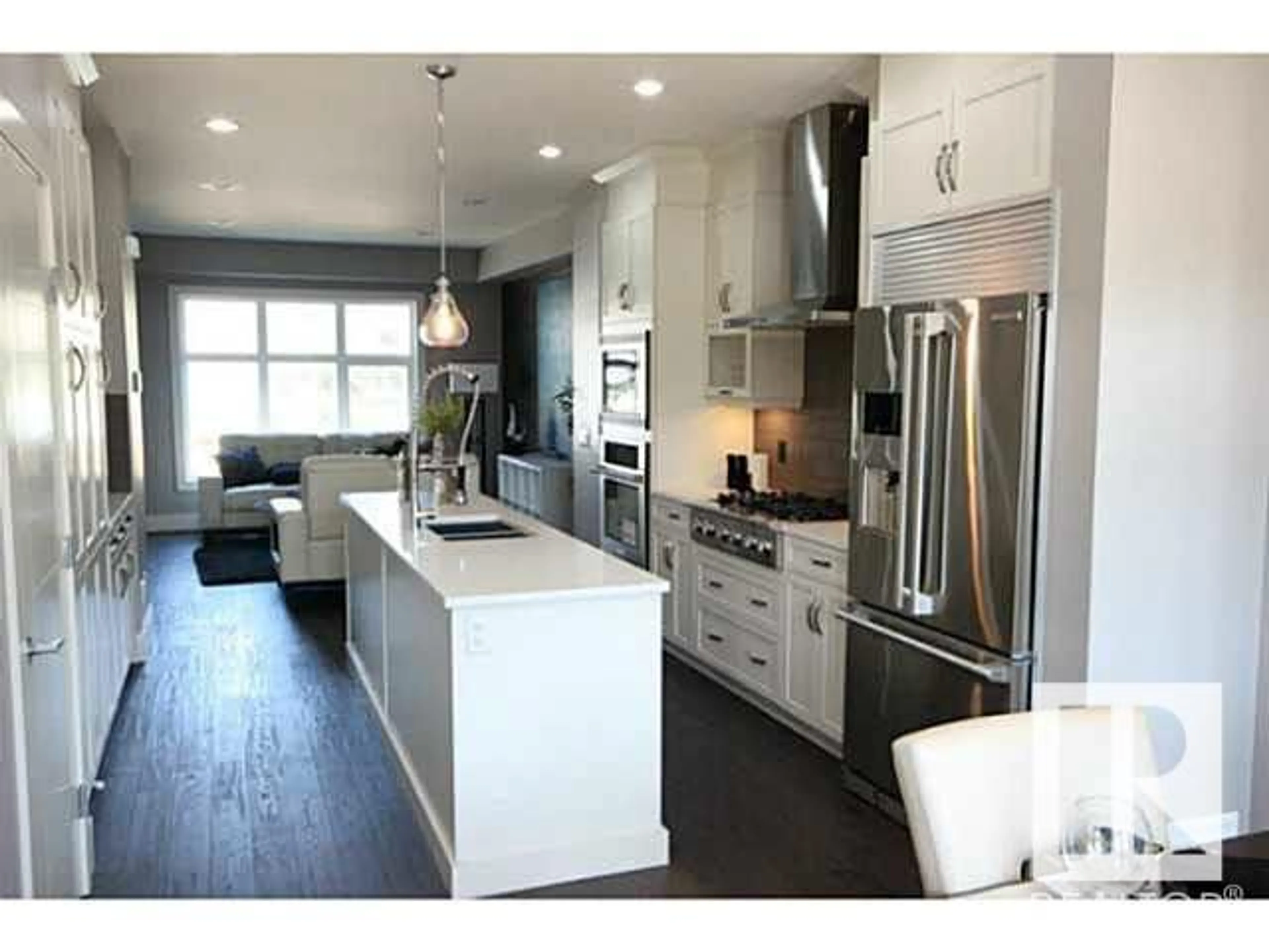 Open concept kitchen, wood/laminate floor for 11333 76 AV NW, Edmonton Alberta T6G0K3