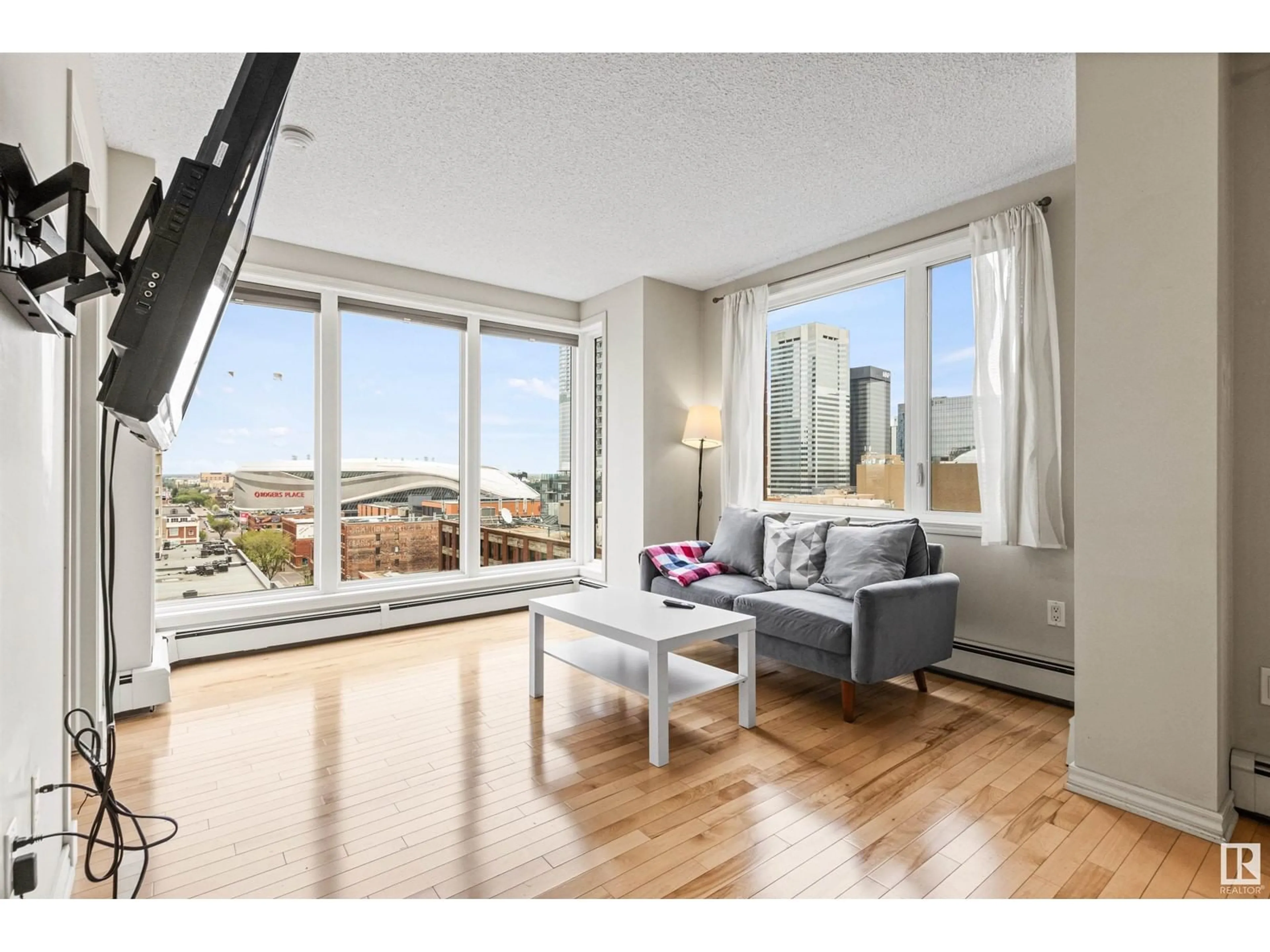 Living room with furniture, wood/laminate floor for 10180 - 1107 104 ST, Edmonton Alberta T5J1A7