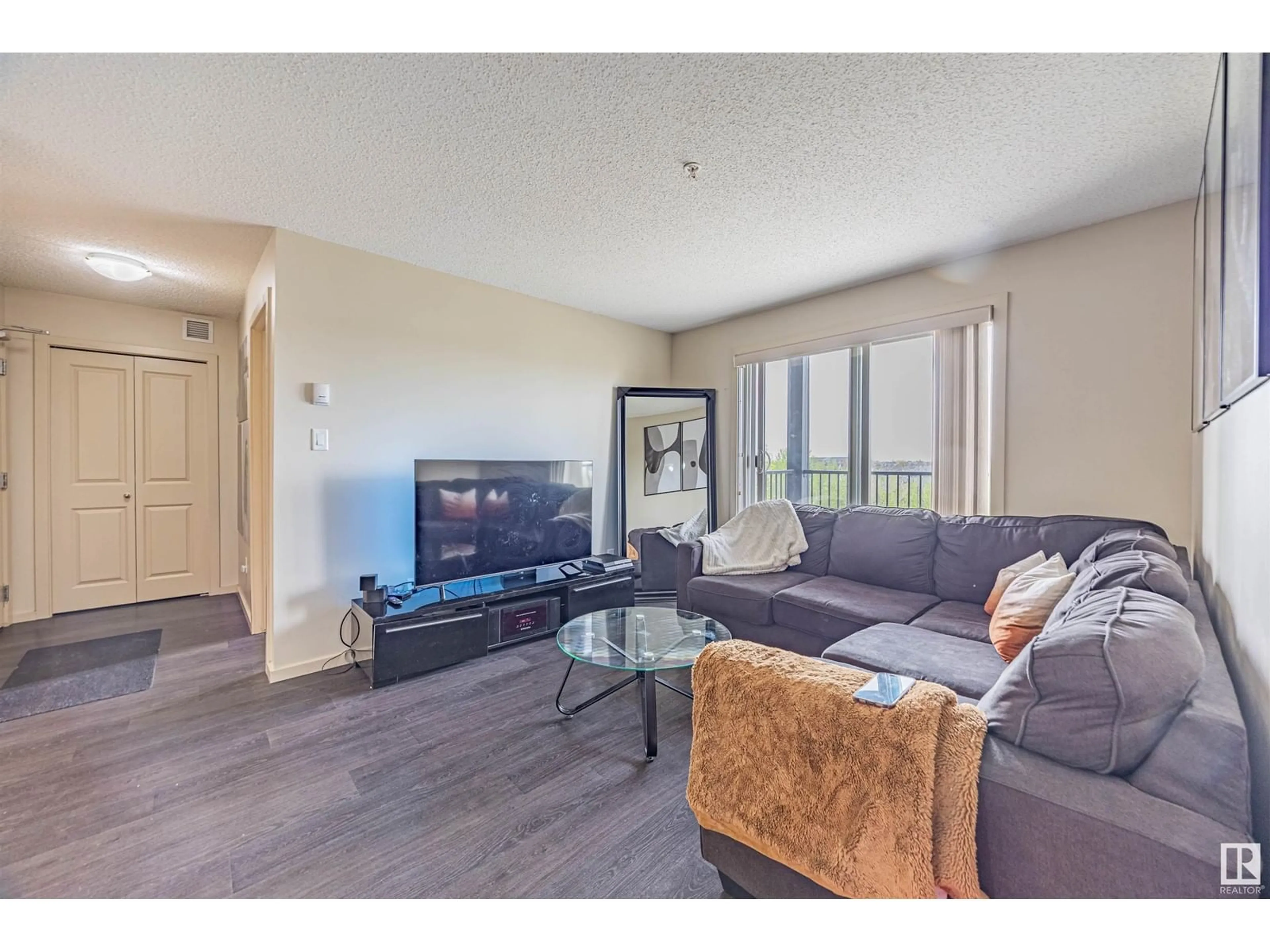 Living room with furniture, wood/laminate floor for 504 - 329 ALBANY WY, Edmonton Alberta T6V0L2