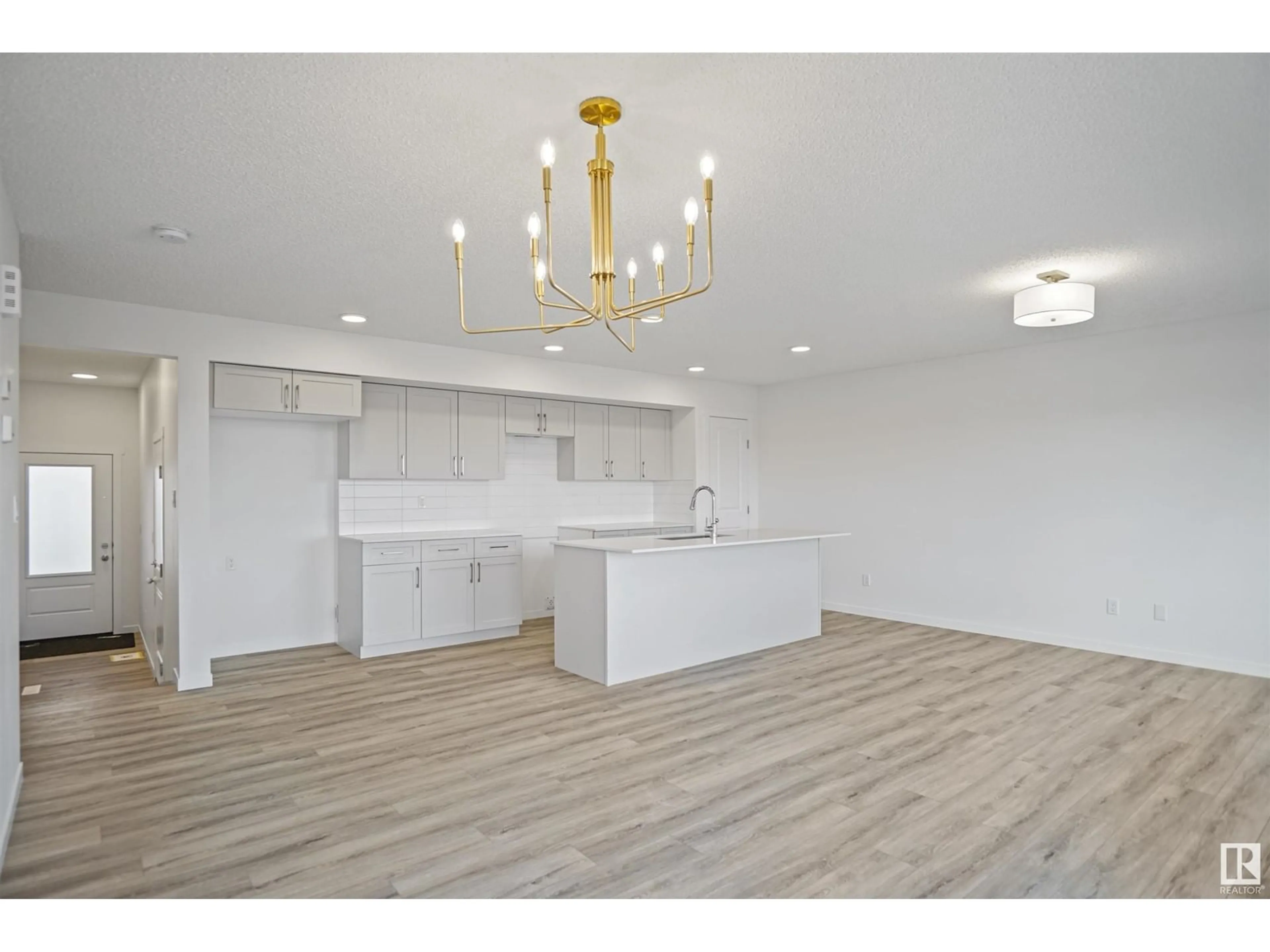 Open concept kitchen, wood/laminate floor for 54 19904 31 AV NW, Edmonton Alberta T6M1N7