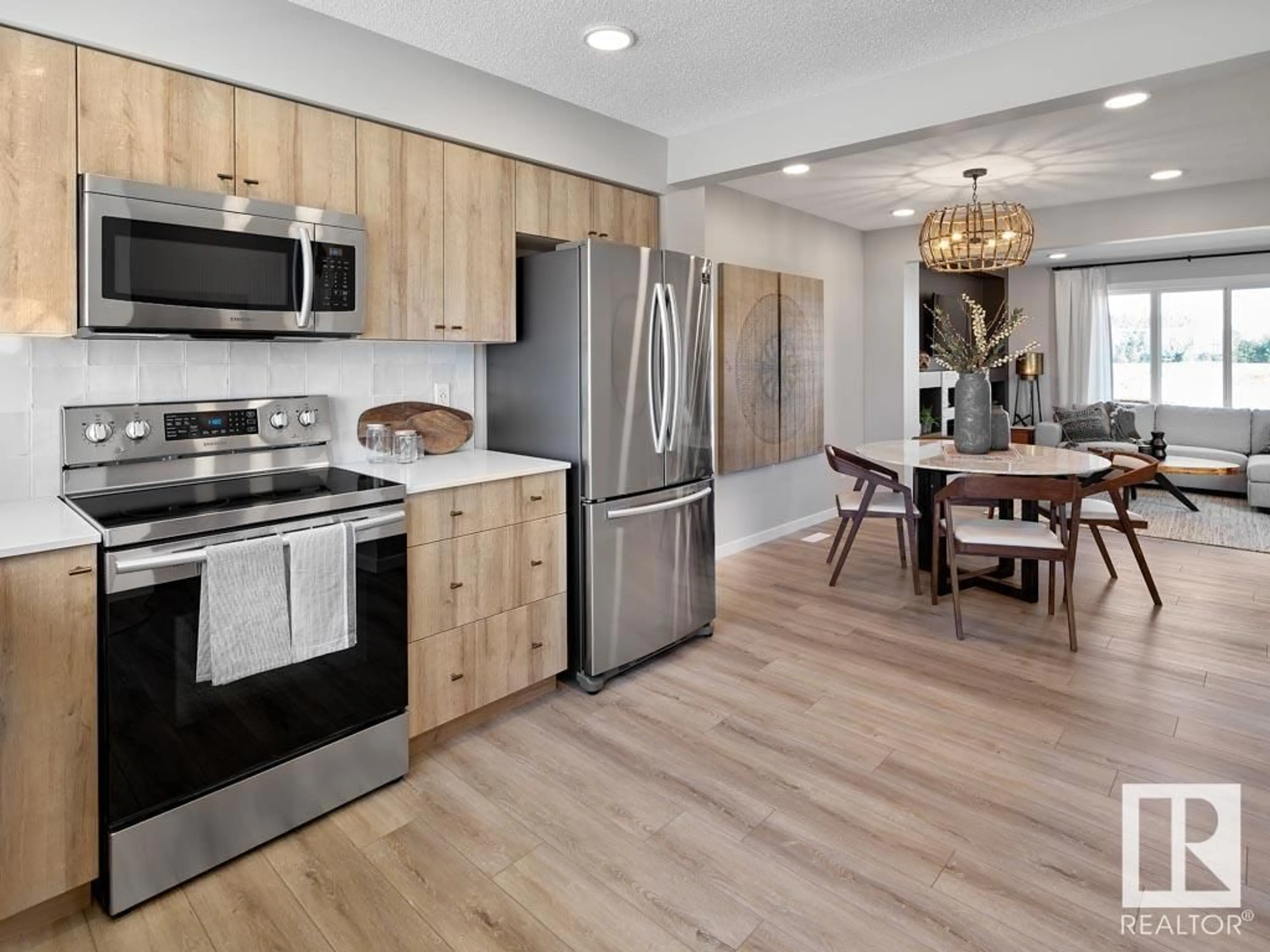 Open concept kitchen, wood/laminate floor for #81 - 1025 SECORD PM, Edmonton Alberta T5T4A4