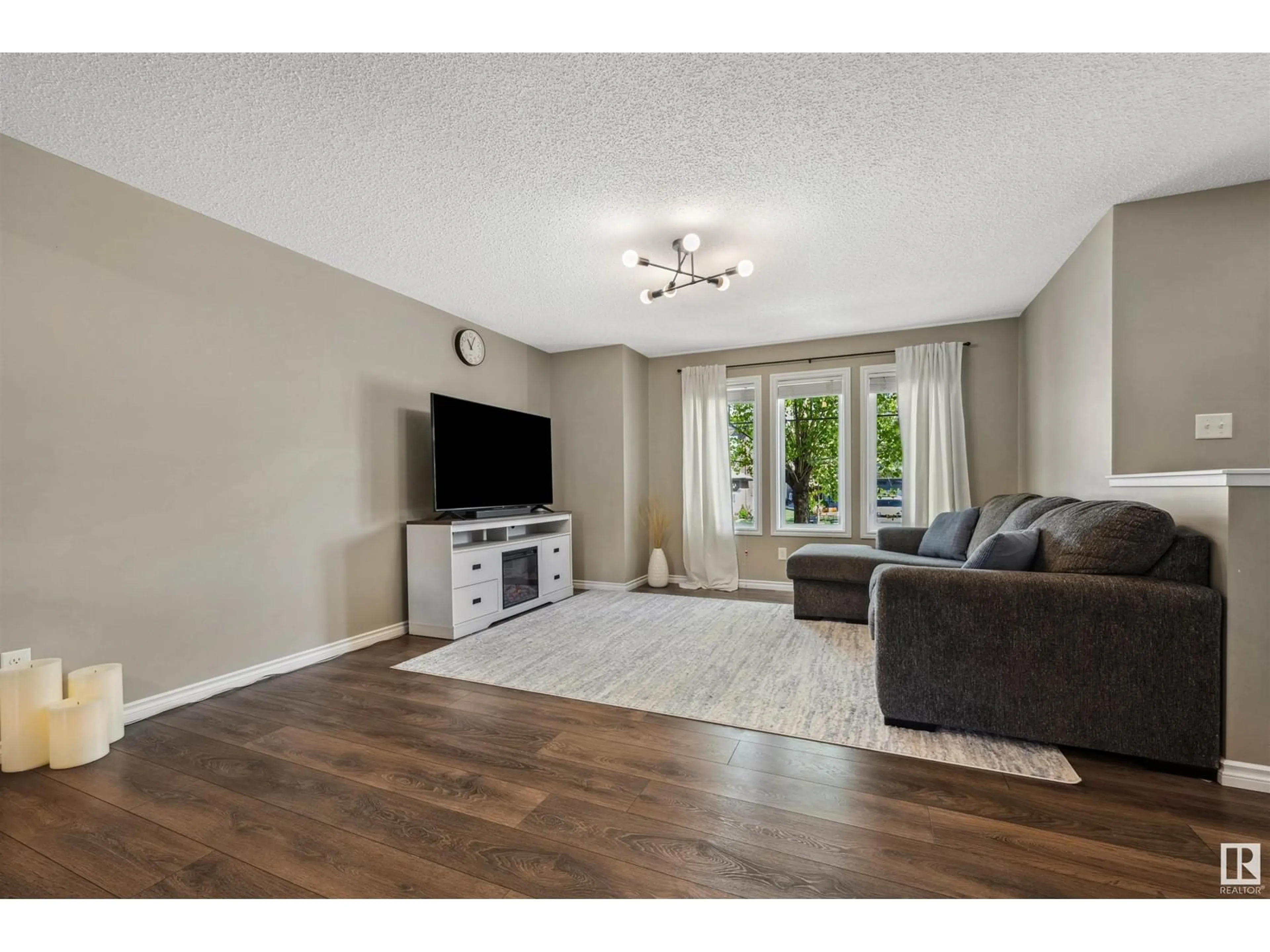 Living room with furniture, wood/laminate floor for 1354 WATT DR, Edmonton Alberta T6X1A3