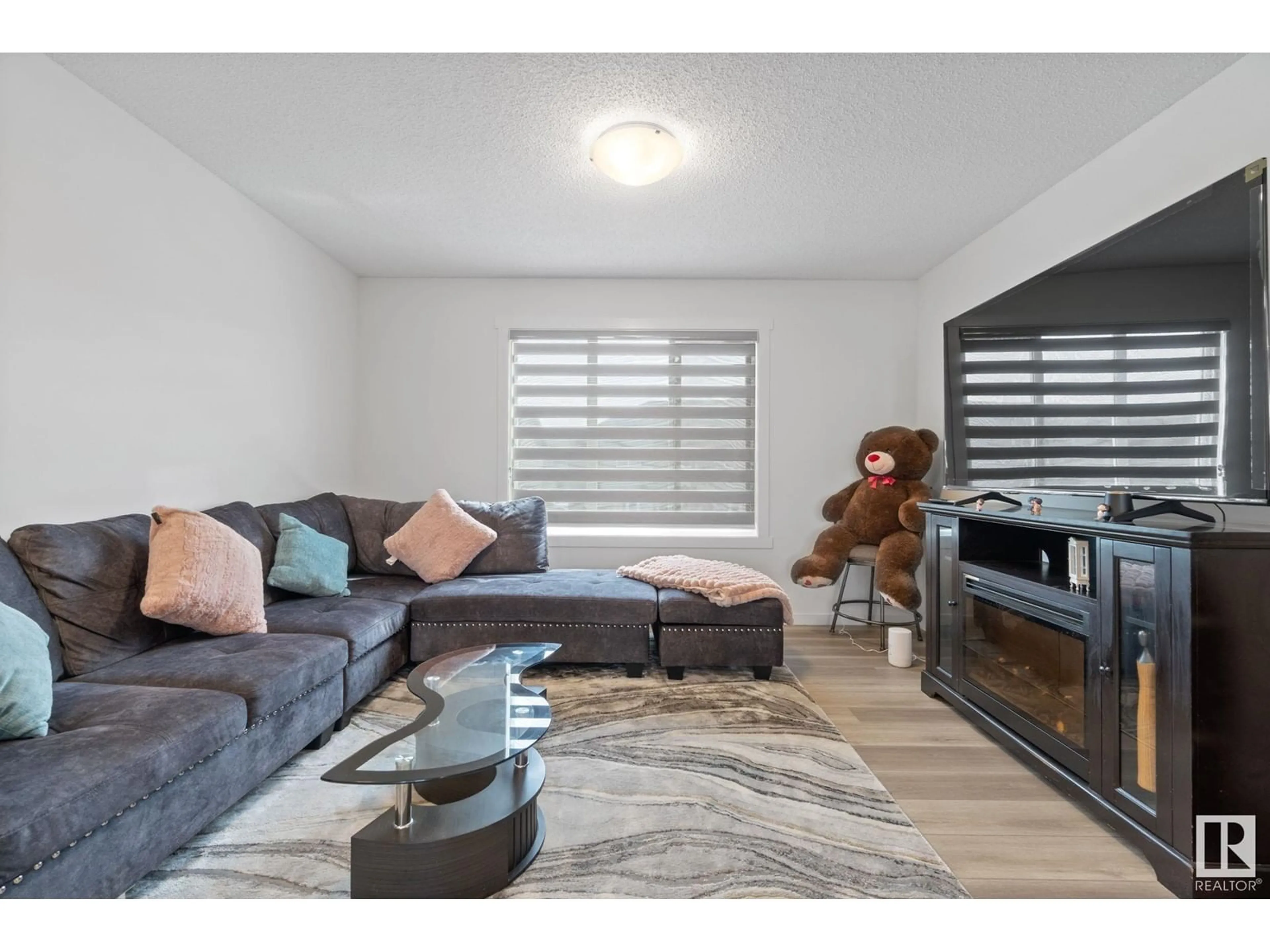Living room with furniture, wood/laminate floor for NW - 22727 84 AV, Edmonton Alberta T5T4B4