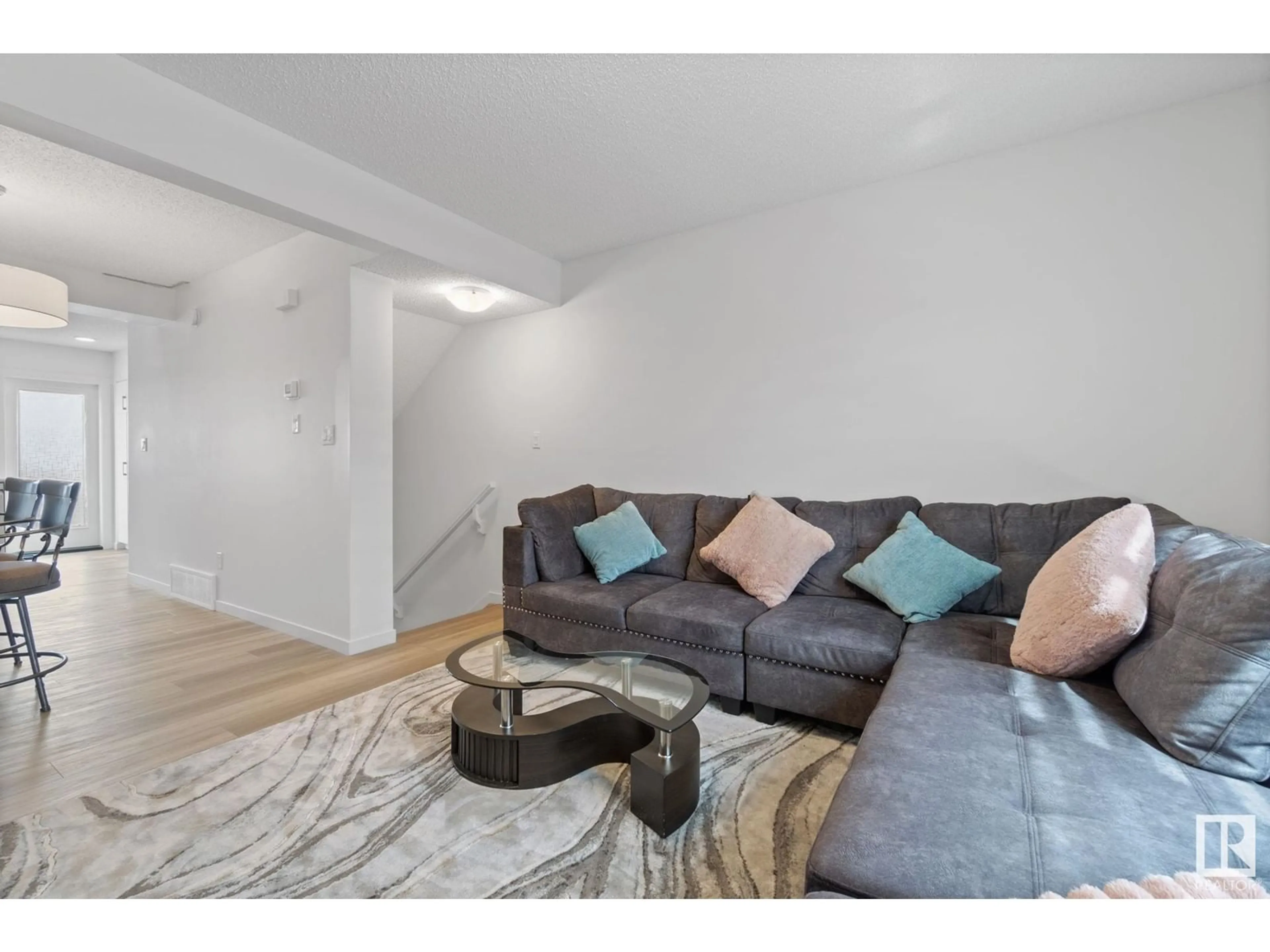 Living room with furniture, wood/laminate floor for NW - 22727 84 AV, Edmonton Alberta T5T4B4