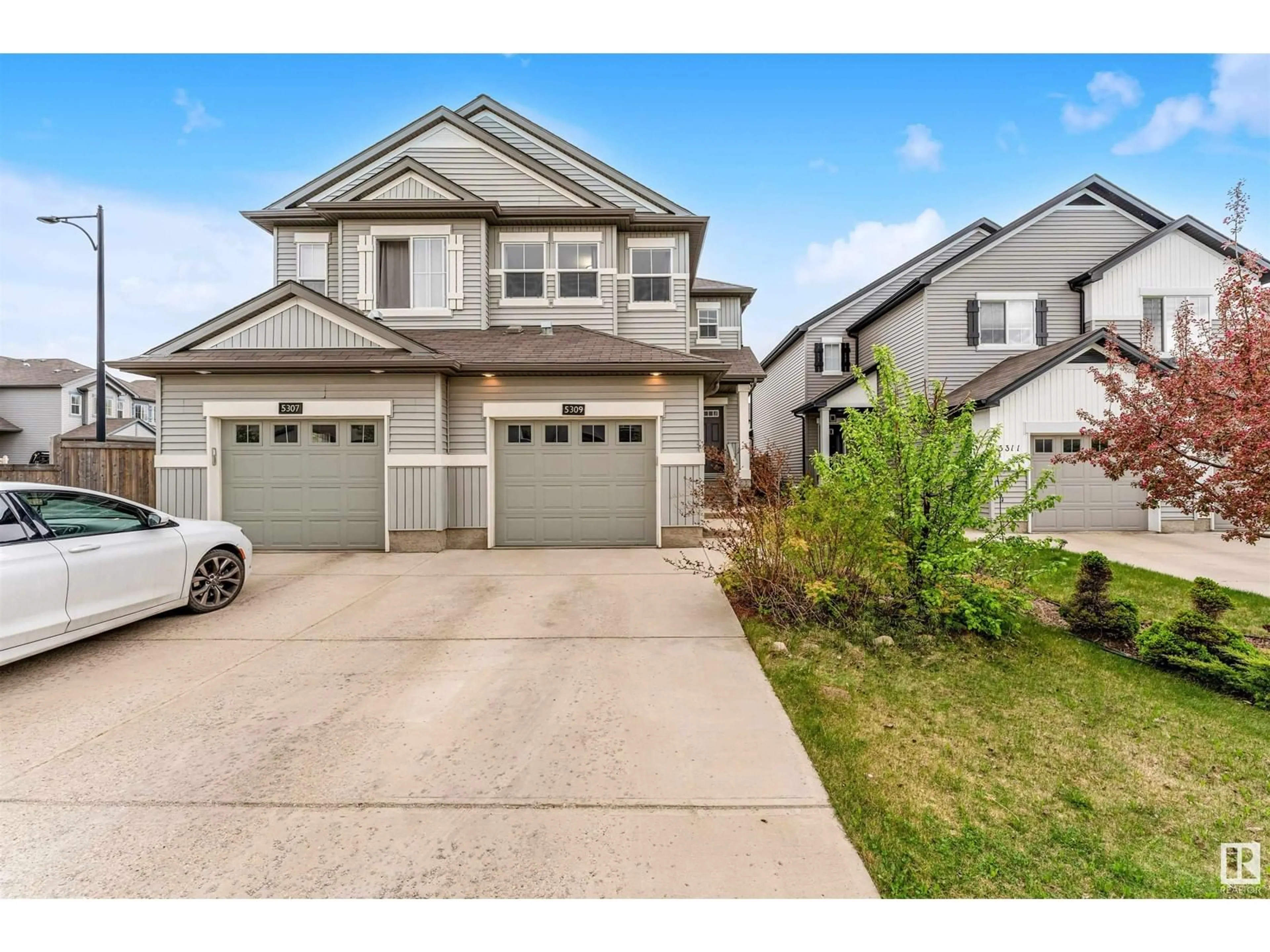 Home with vinyl exterior material, street for 5309 14 AV SW, Edmonton Alberta T6X1S2