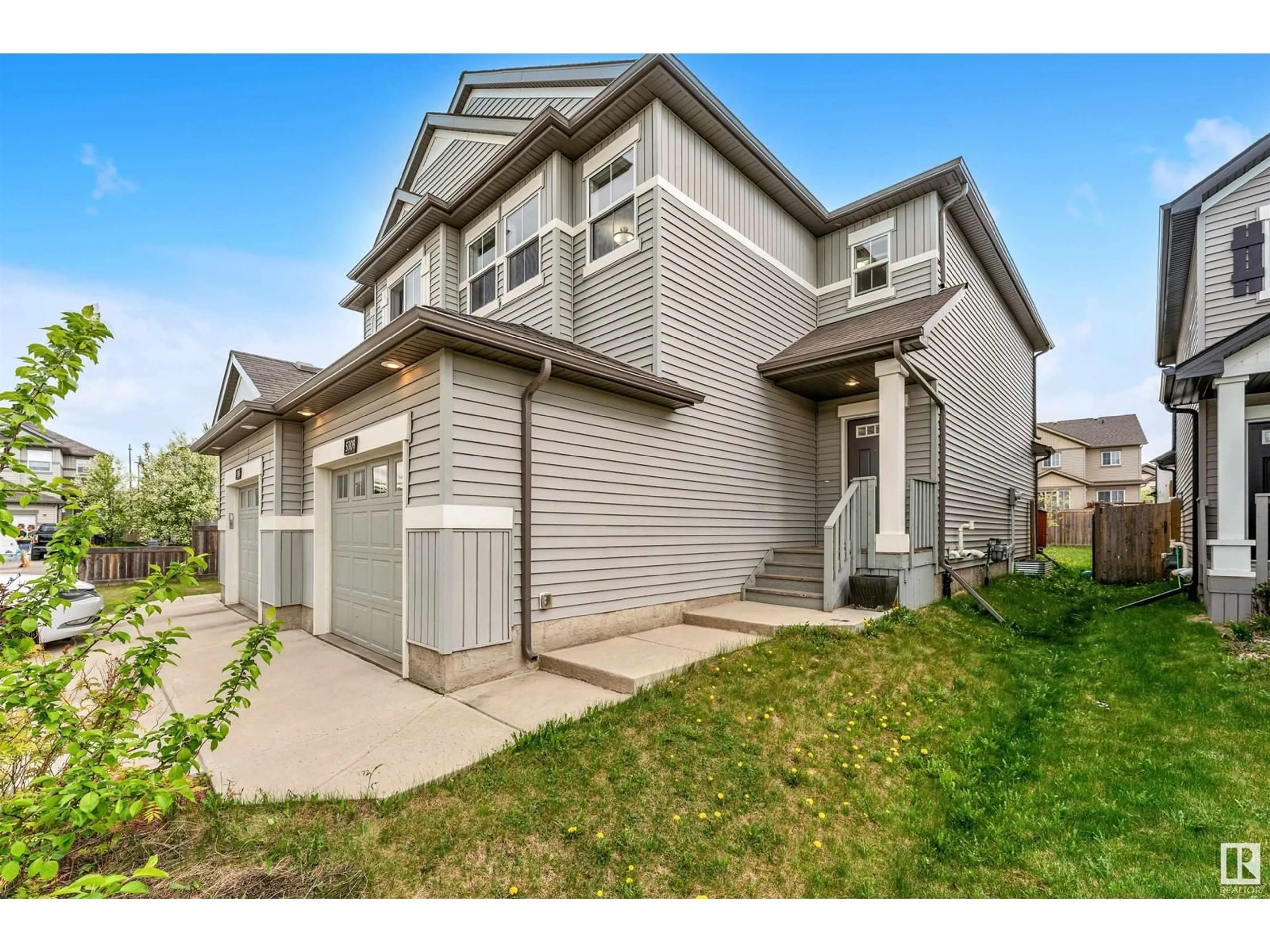 Home with vinyl exterior material, street for 5309 14 AV SW, Edmonton Alberta T6X1S2