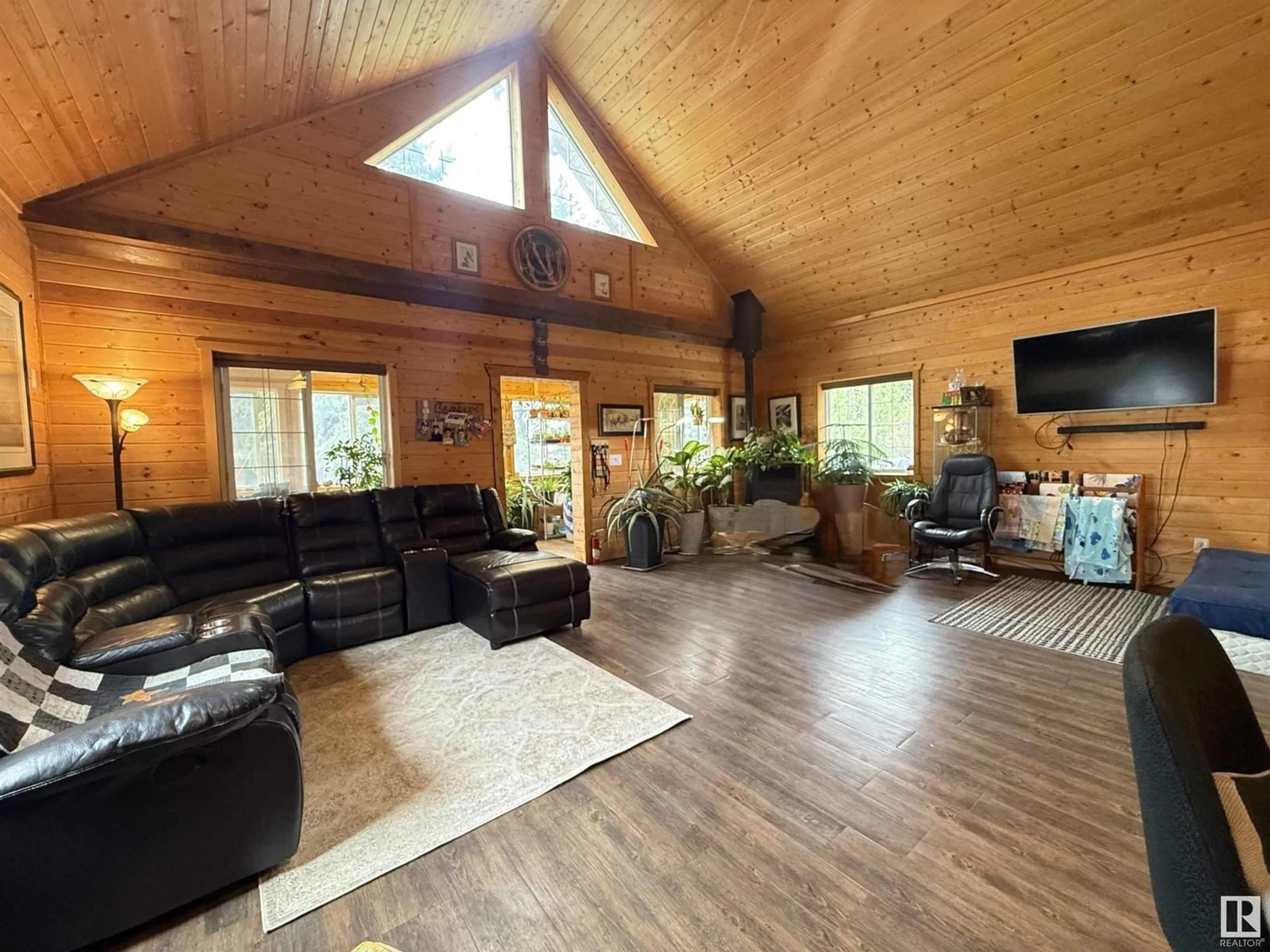 Living room with furniture, wood/laminate floor for 54115 HWY 44, Rural Sturgeon County Alberta T8T0J6