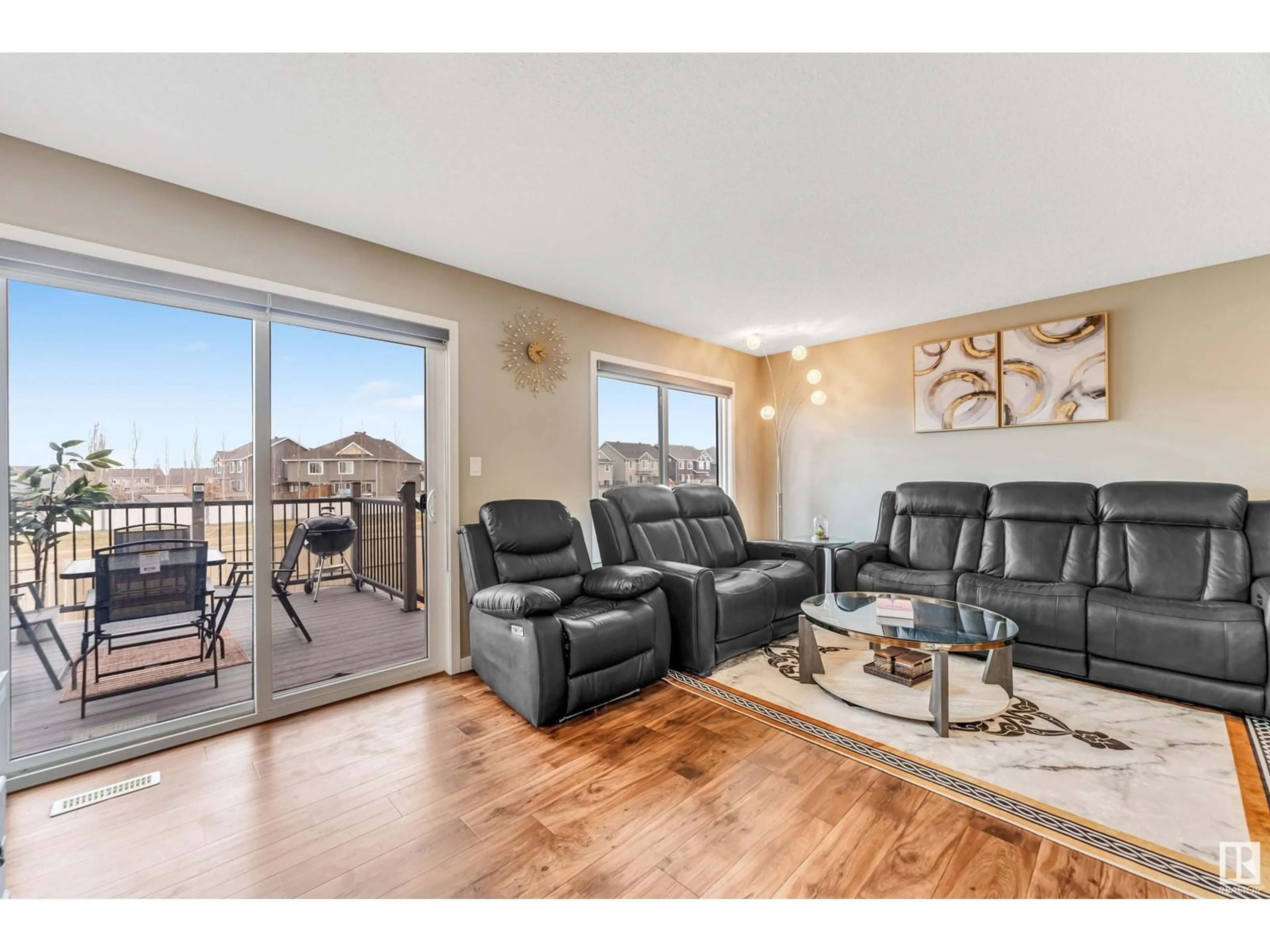 Living room with furniture, wood/laminate floor for 2769 CHOKECHERRY PL, Edmonton Alberta T6X2J9