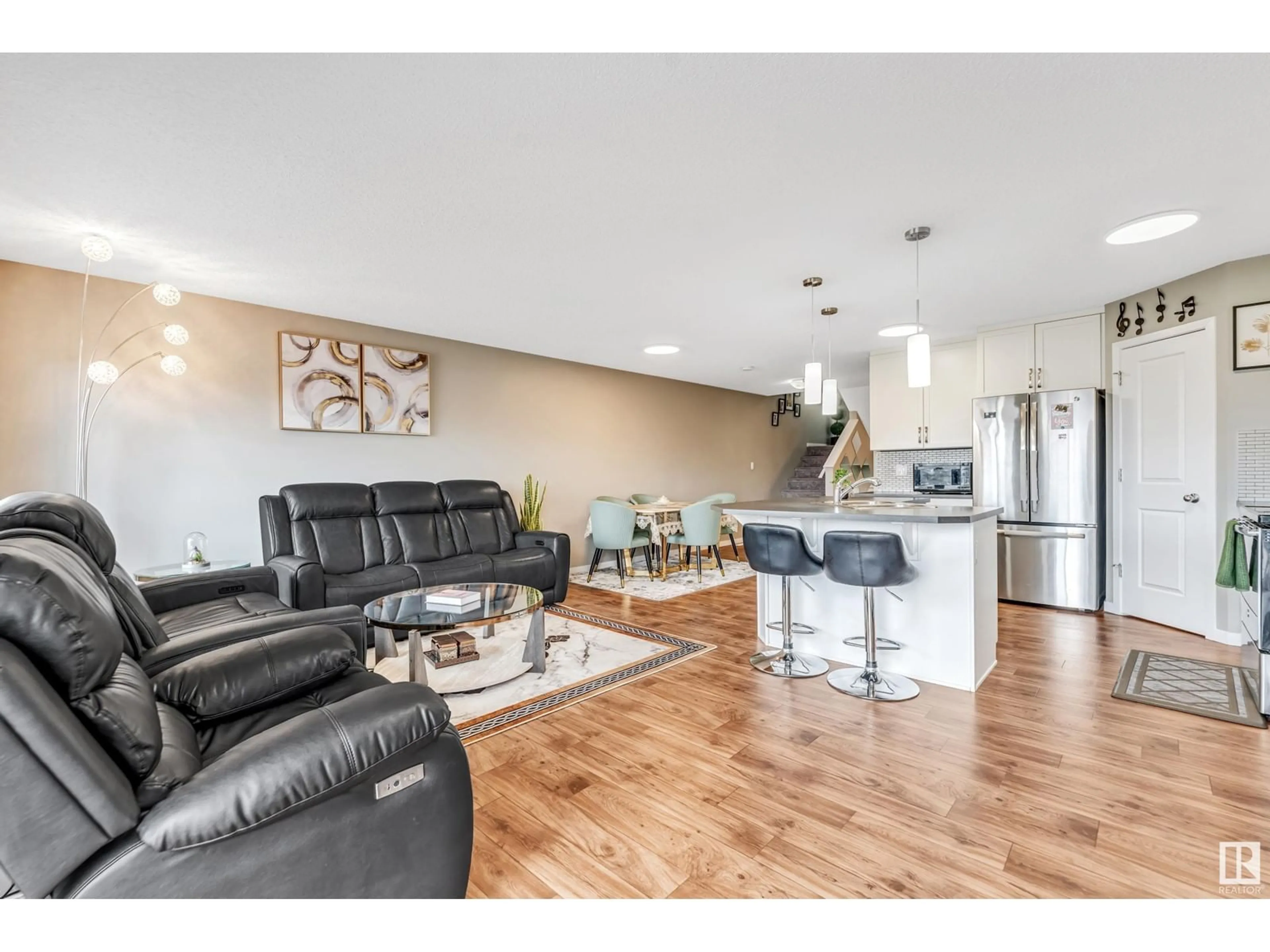 Living room with furniture, wood/laminate floor for 2769 CHOKECHERRY PL, Edmonton Alberta T6X2J9