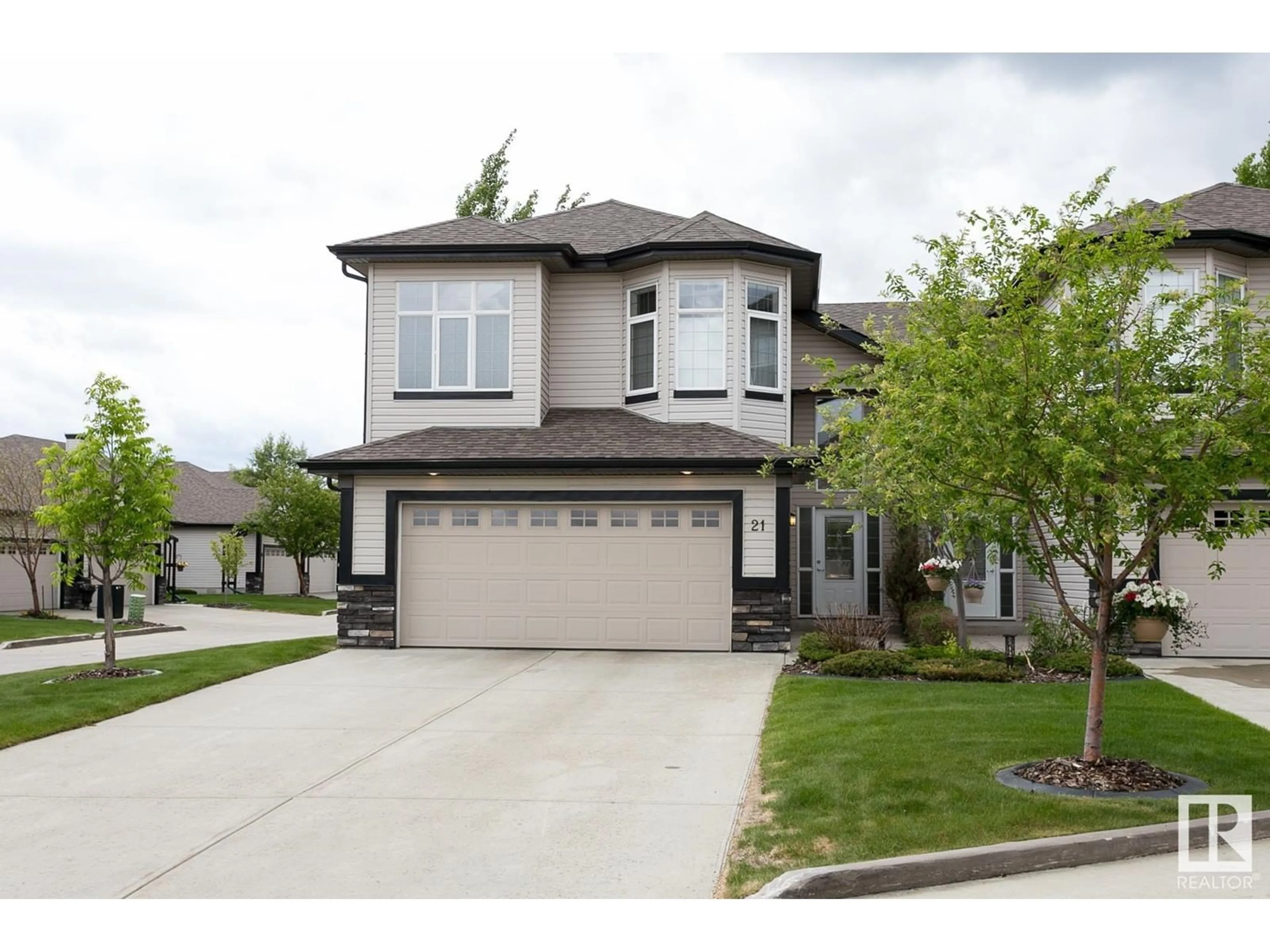Home with vinyl exterior material, street for 12610 15 AV SW, Edmonton Alberta T6W1X1