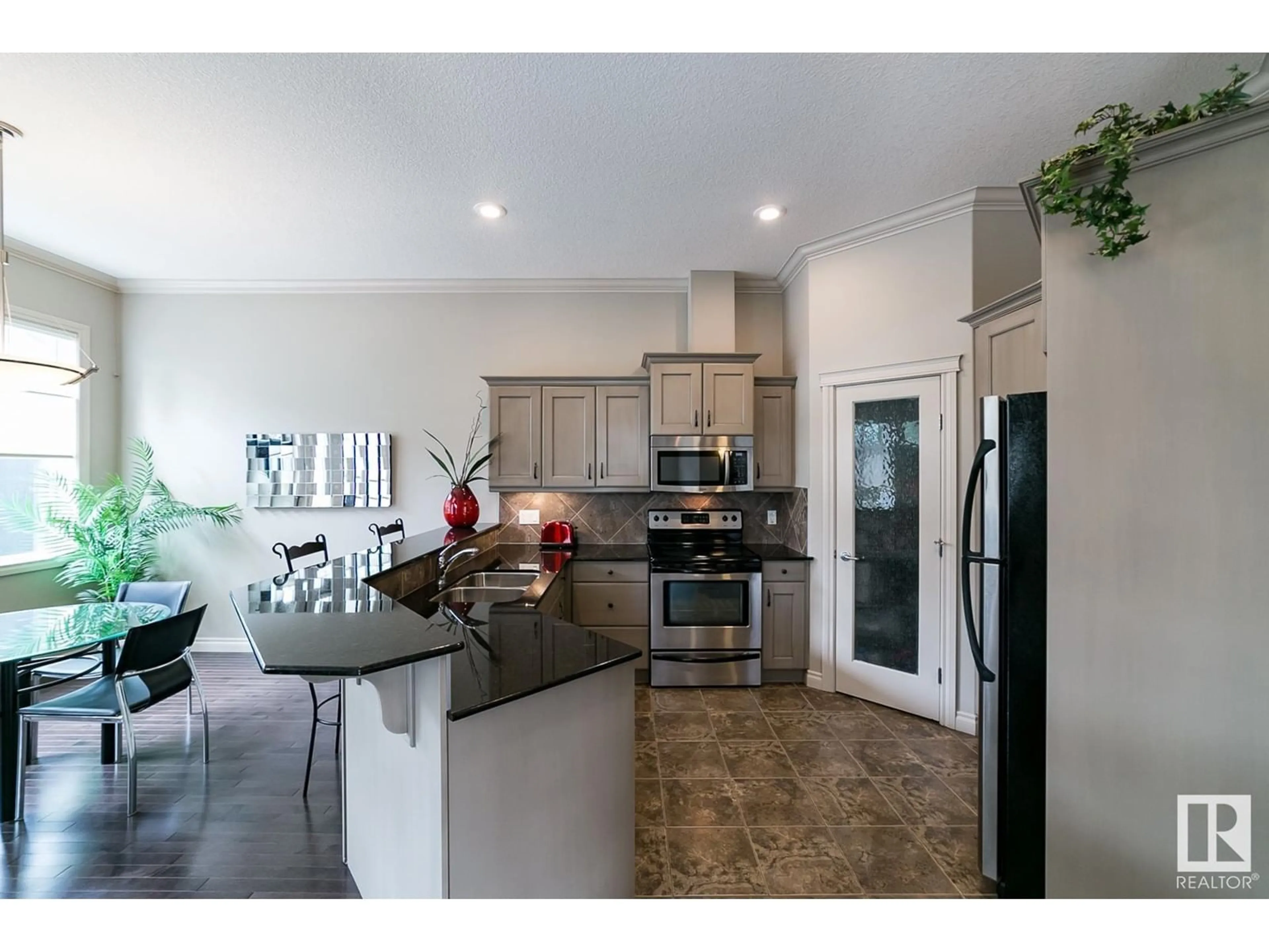 Open concept kitchen, ceramic/tile floor for 12610 15 AV SW, Edmonton Alberta T6W1X1