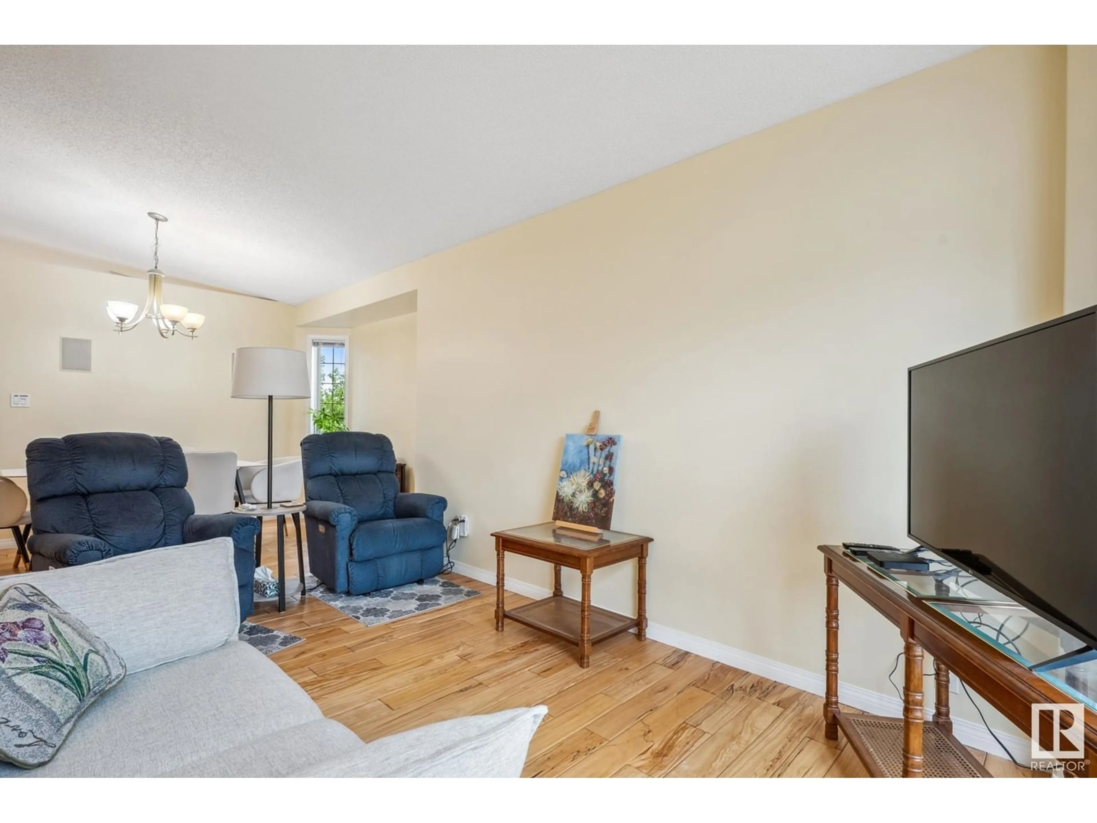 Living room with furniture, wood/laminate floor for 7 - 39 CRANFORD WY, Sherwood Park Alberta T8H5W5
