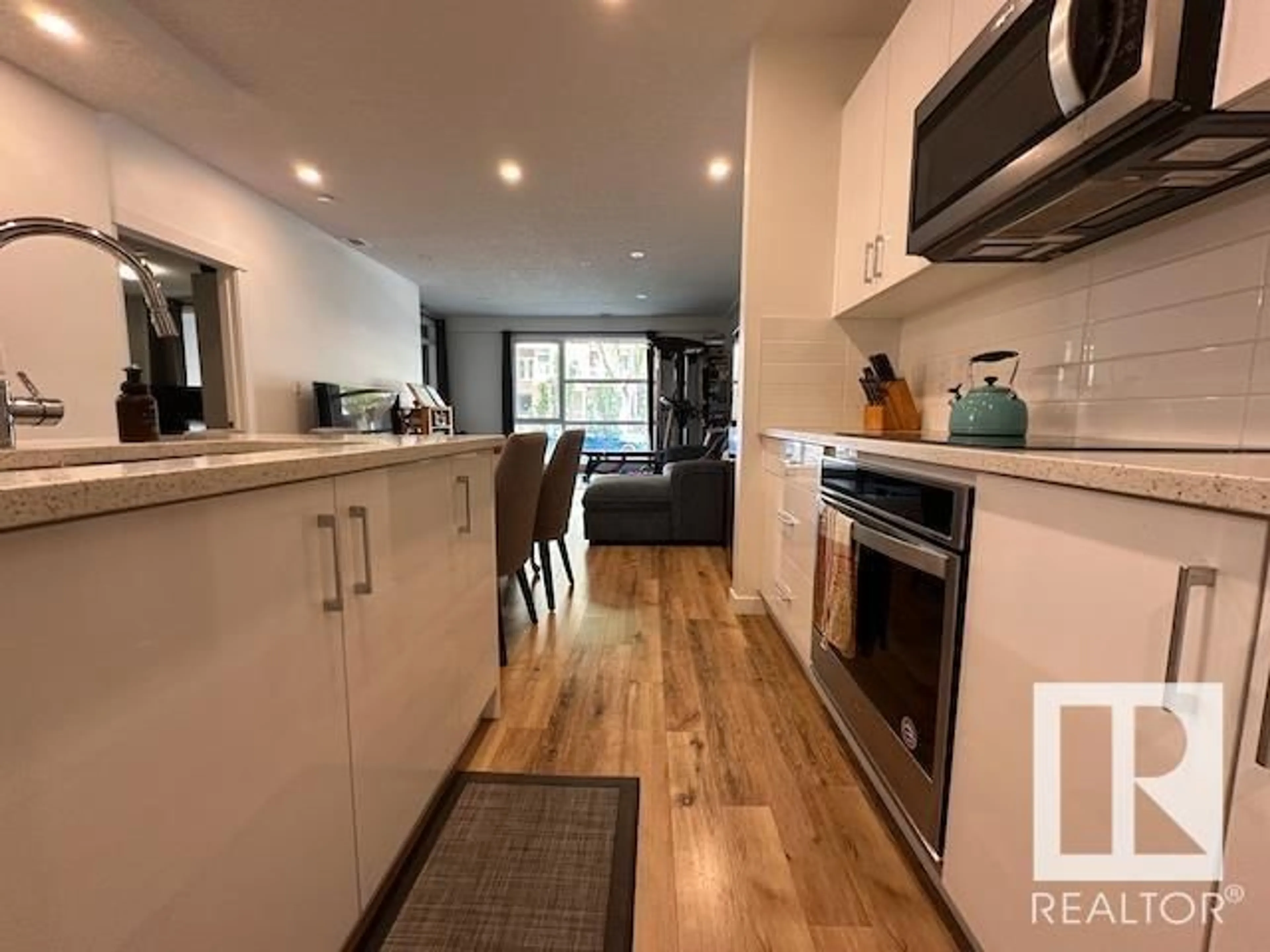 Open concept kitchen, wood/laminate floor for #117 - 11503 76 AV, Edmonton Alberta T6G0L6