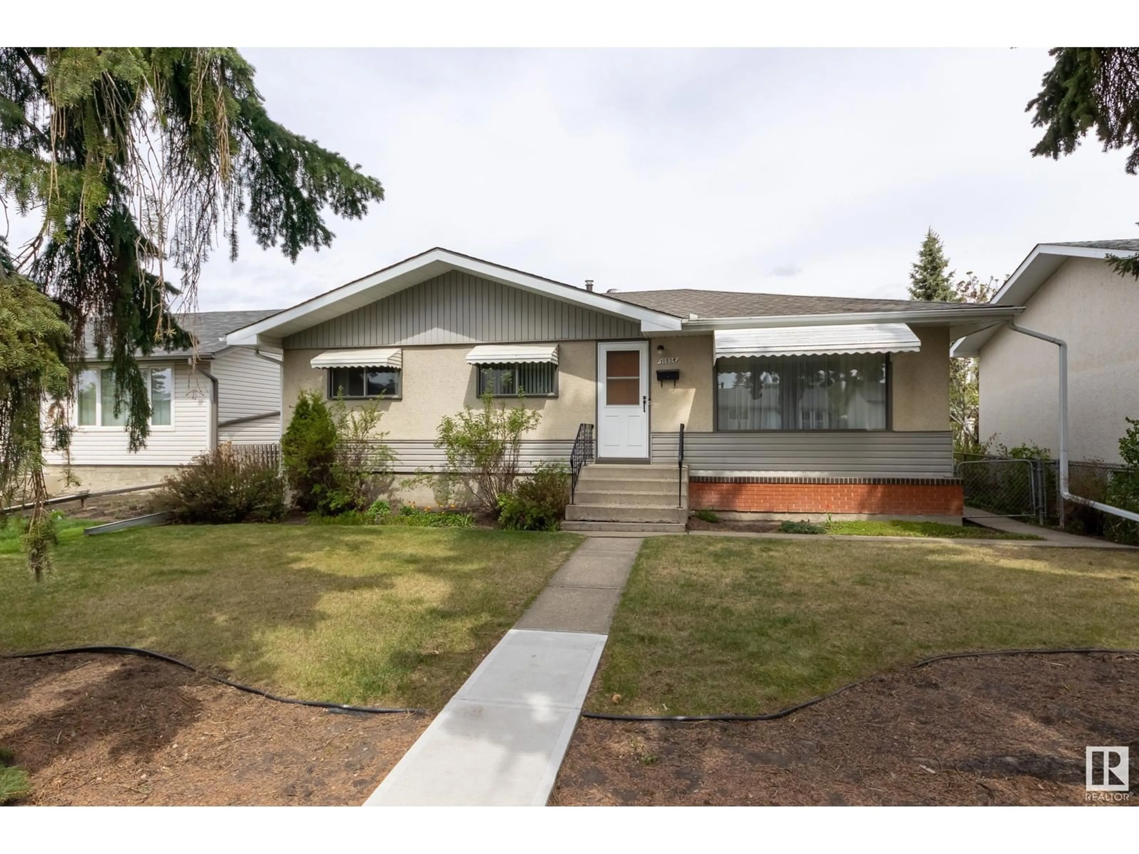 Home with vinyl exterior material, street for 10804 52 AV, Edmonton Alberta T6H0P3