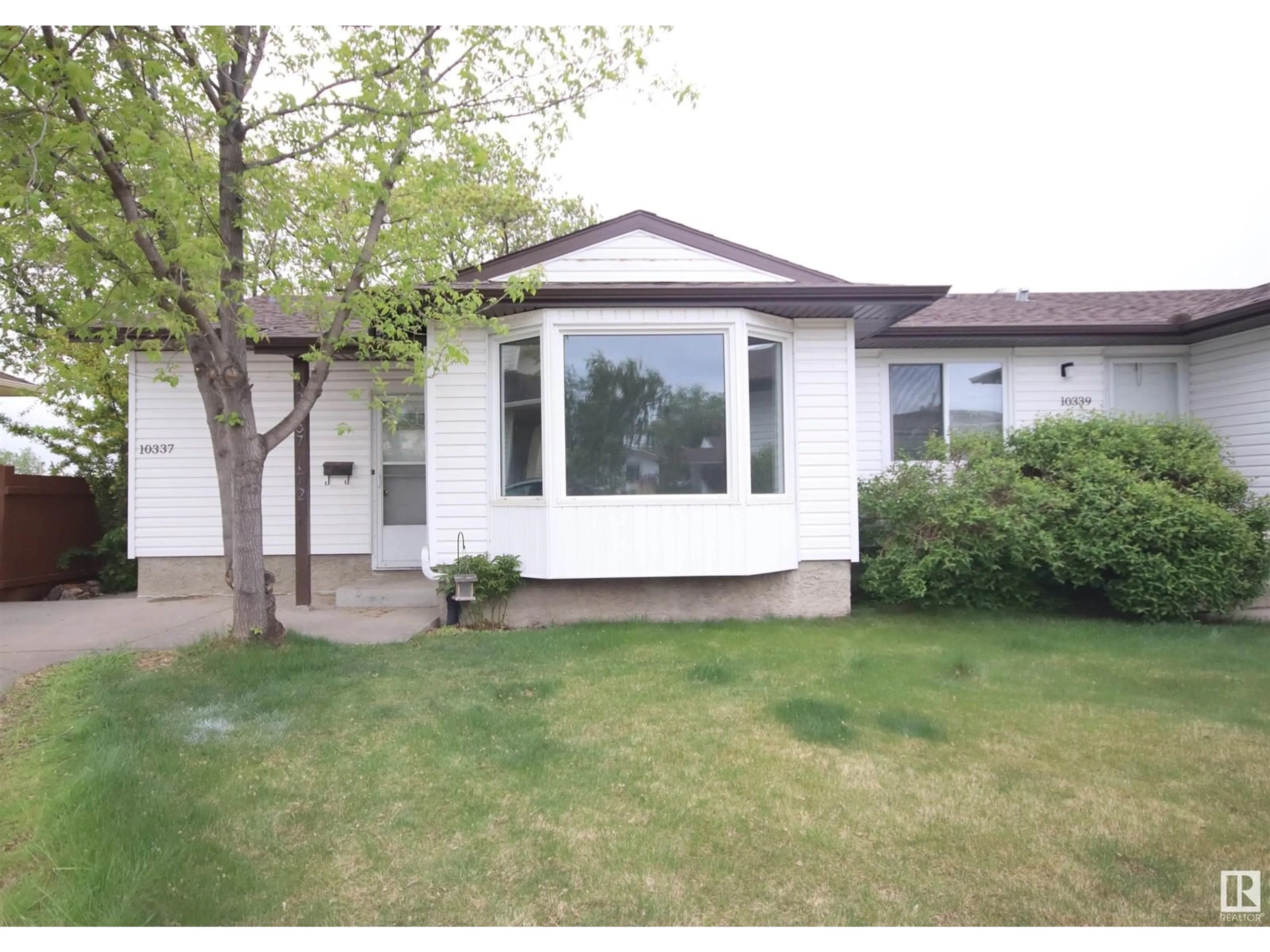 Home with vinyl exterior material, street for 10337 172 AV, Edmonton Alberta T5X5C2