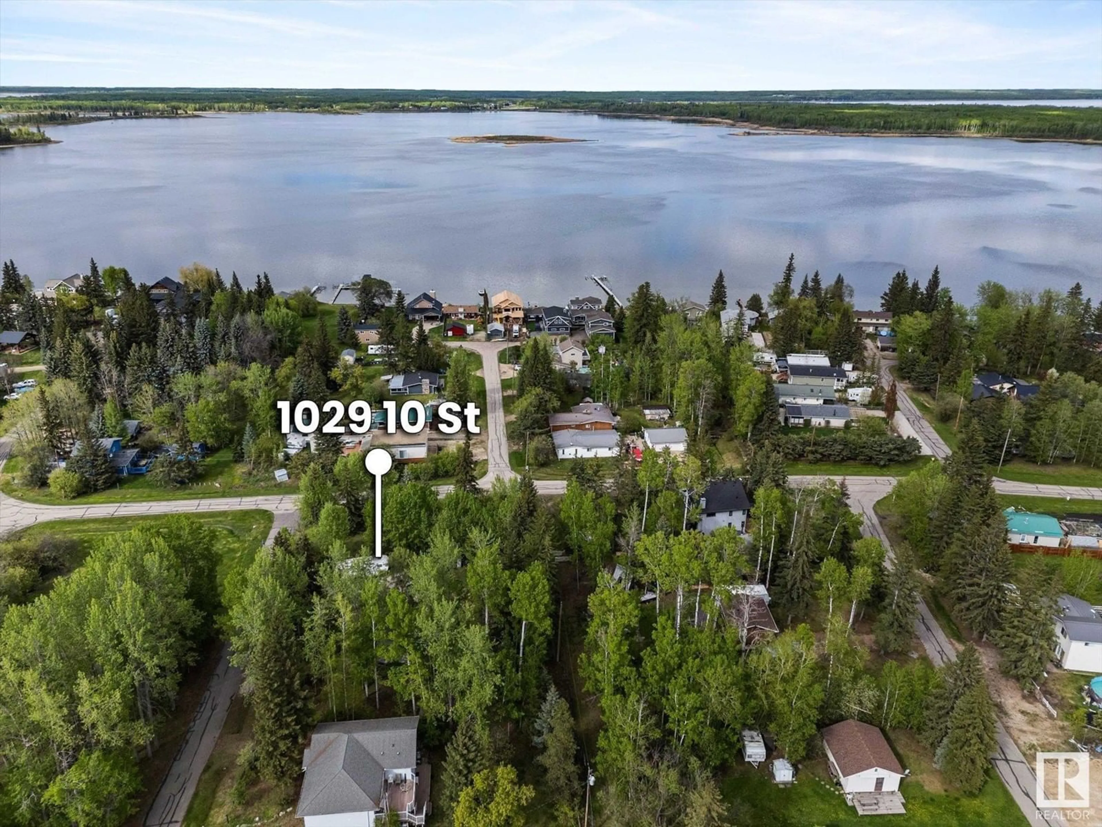 A pic from outside/outdoor area/front of a property/back of a property/a pic from drone, water/lake/river/ocean view for 1028-1029 10 ST, Rural Lac Ste. Anne County Alberta T0E0A2