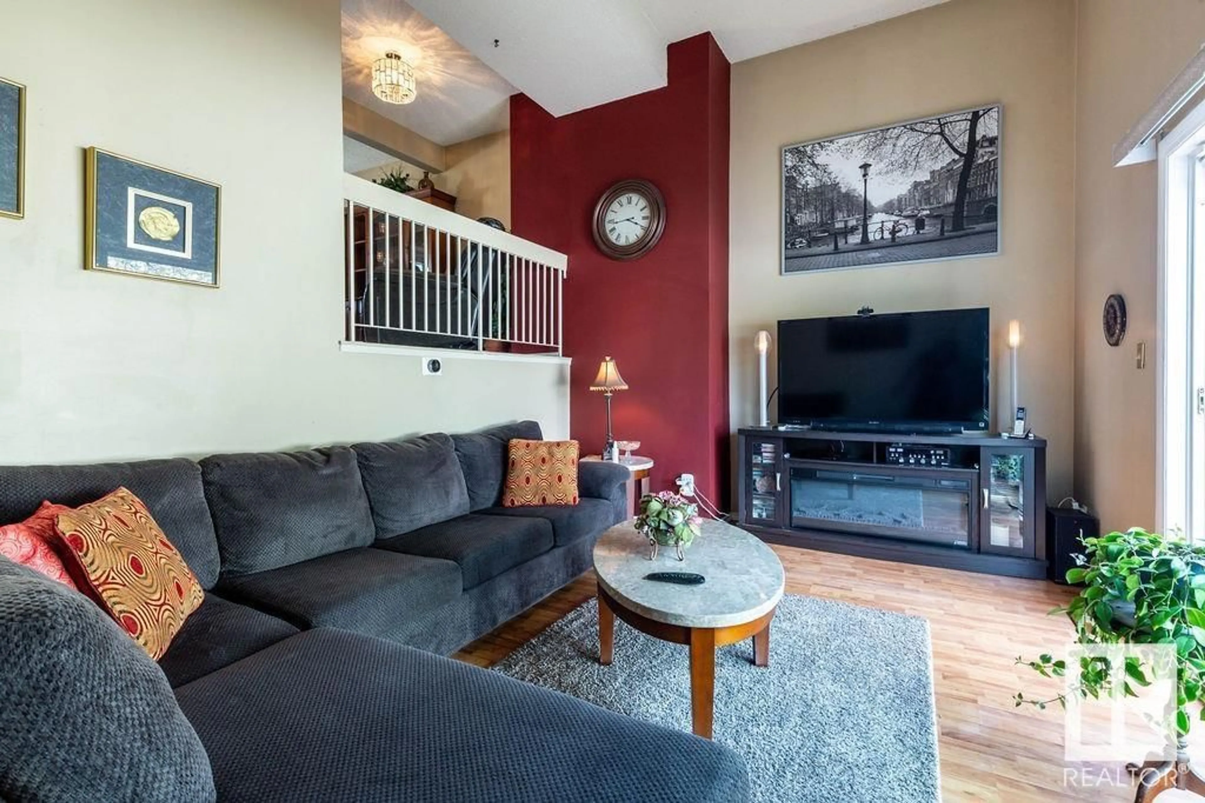 Living room with furniture, wood/laminate floor for 11914 145 AV, Edmonton Alberta T5X1T6