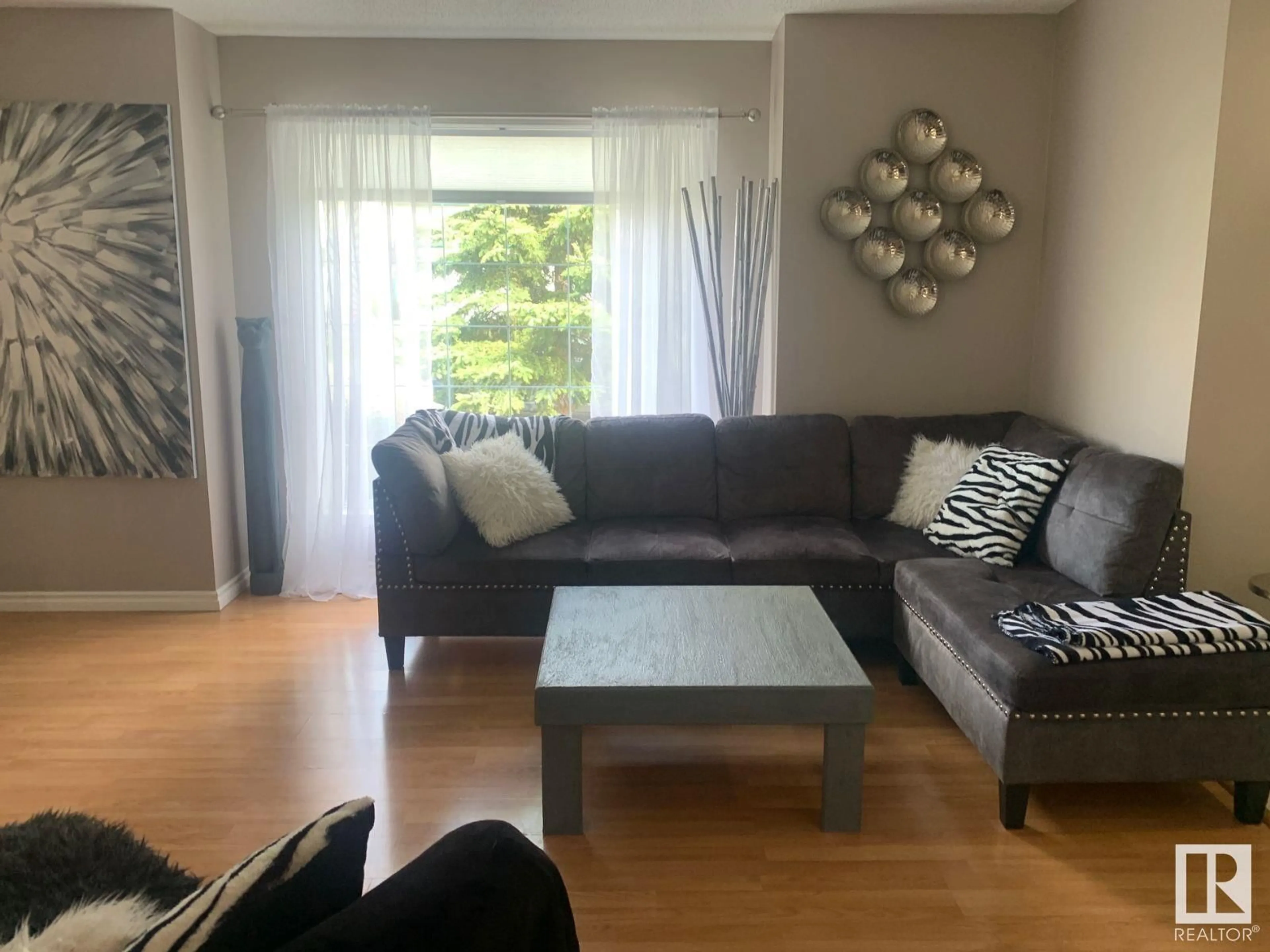 Living room with furniture, wood/laminate floor for NW - 15024 128 ST, Edmonton Alberta T6V1E9