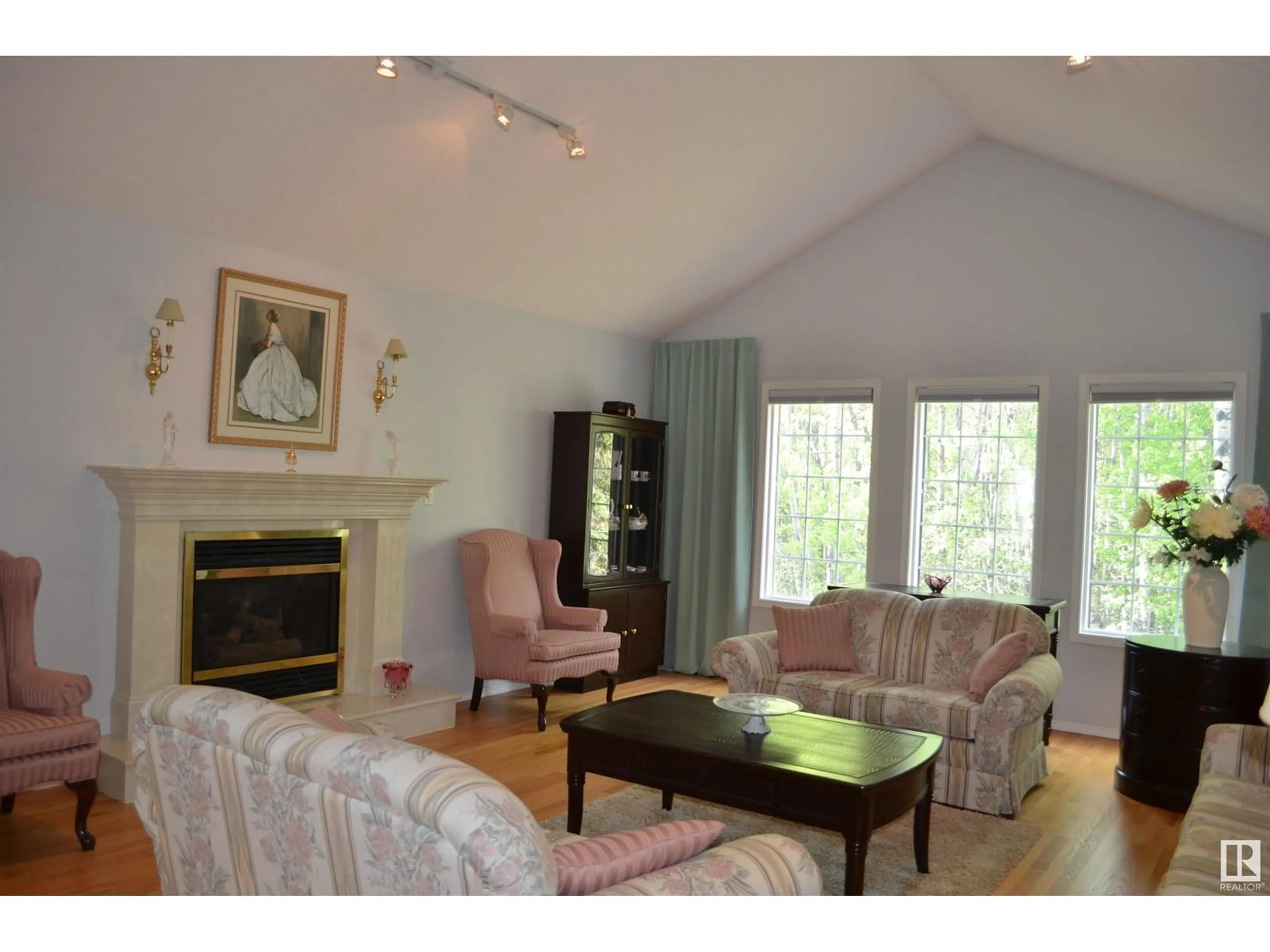 Living room with furniture, wood/laminate floor for 37 - 51128 RGE ROAD 261, Rural Parkland County Alberta T7Y1B8
