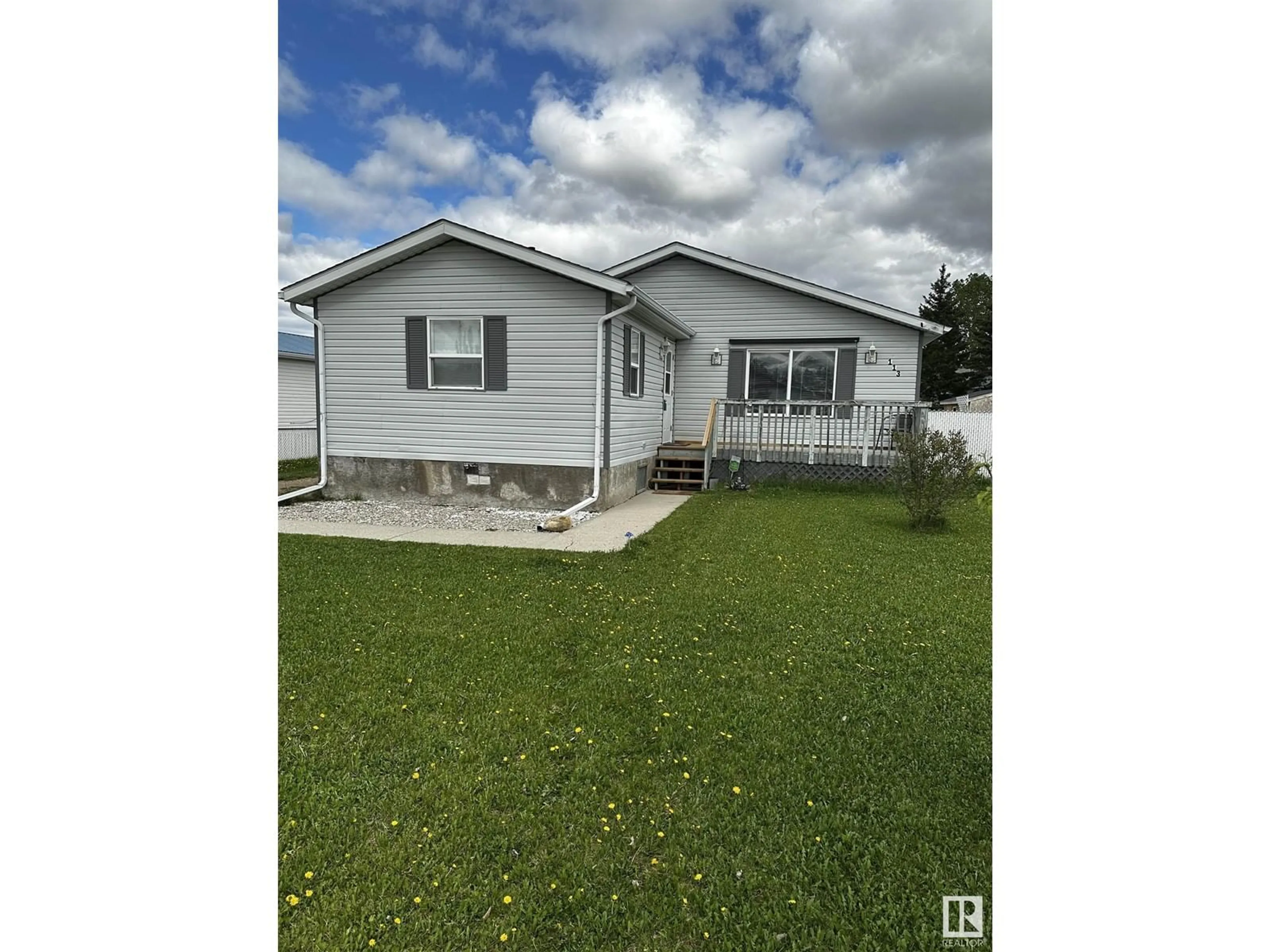 Home with vinyl exterior material, street for 113 WOODLANDS DR, Warburg Alberta T0C2T0