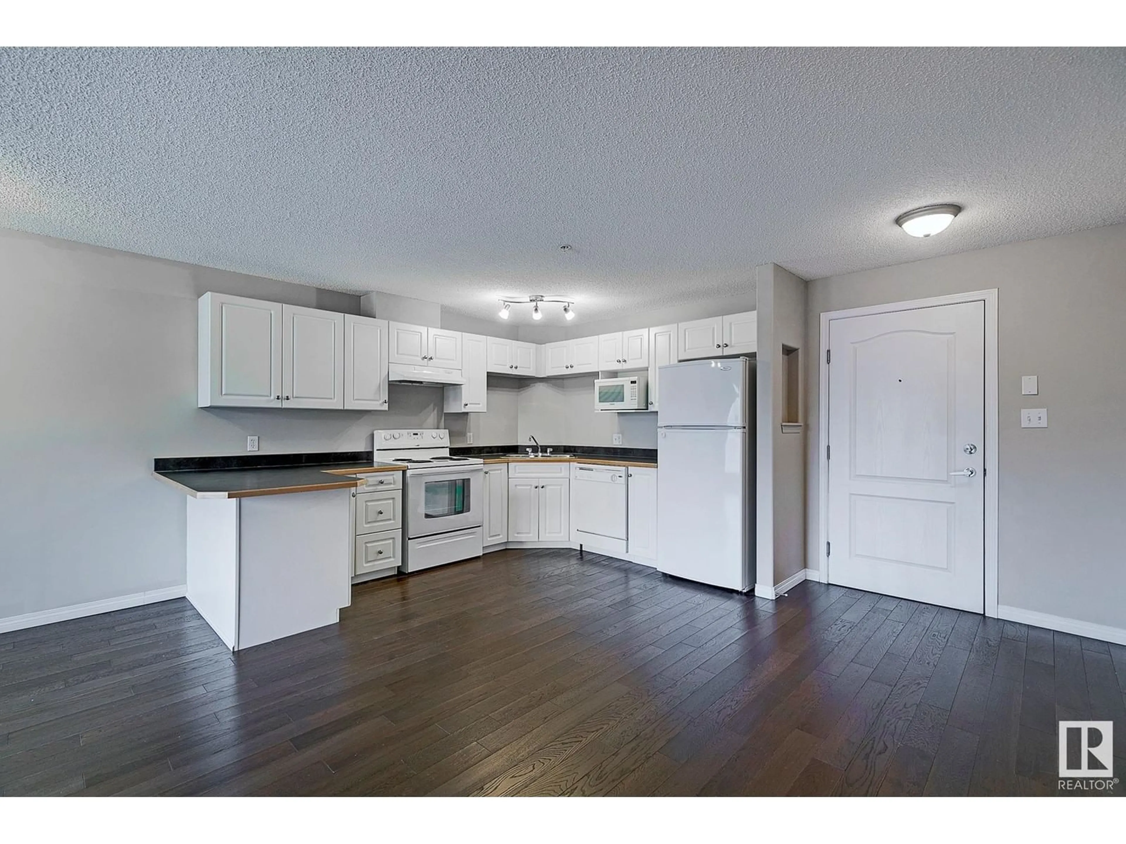 Open concept kitchen, wood/laminate floor for #212 - 5350 199 ST, Edmonton Alberta T6M0A4