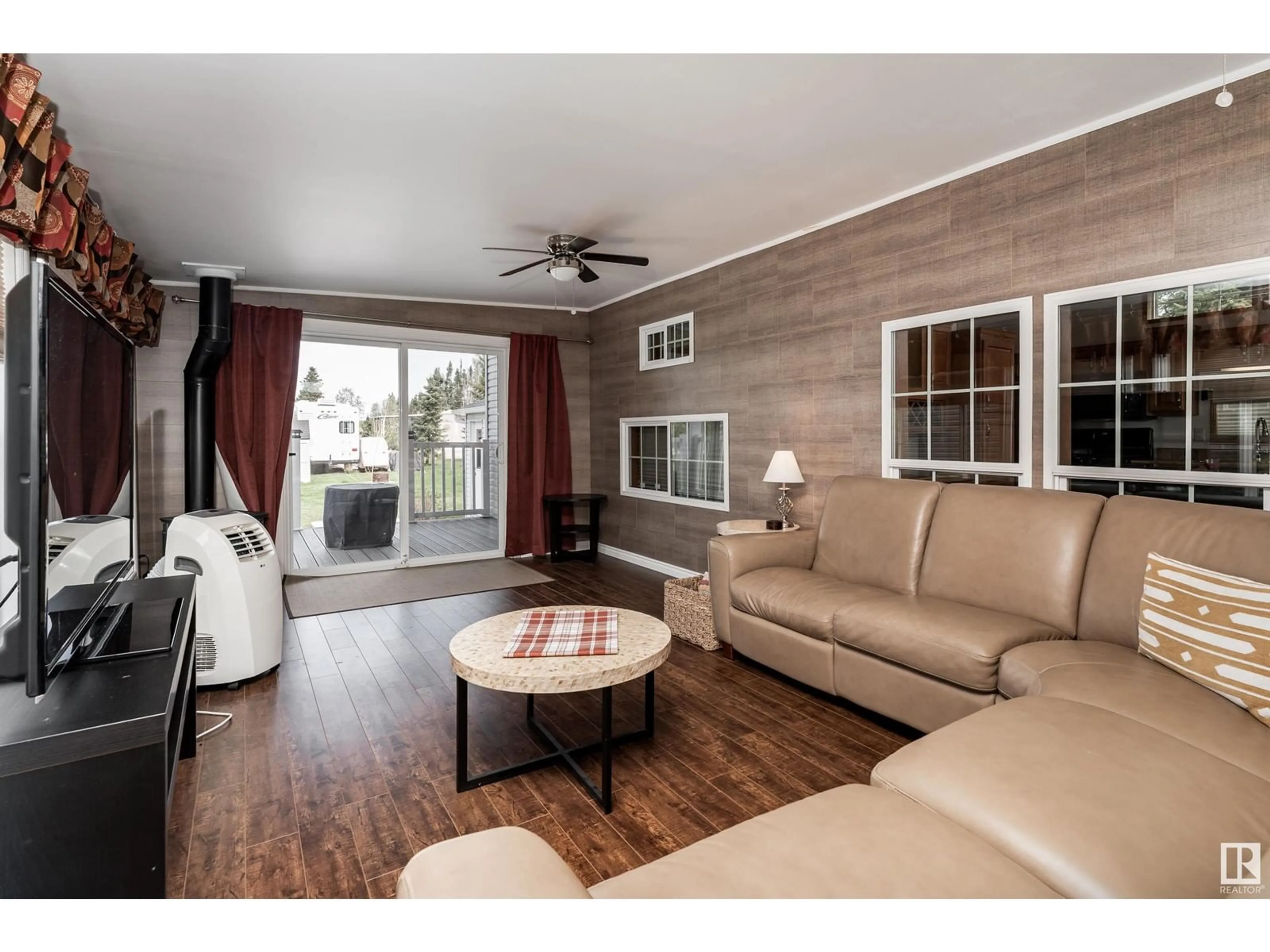 Living room with furniture, wood/laminate floor for 174 RGE ROAD 70, Rural Parkland County Alberta T0E0S0